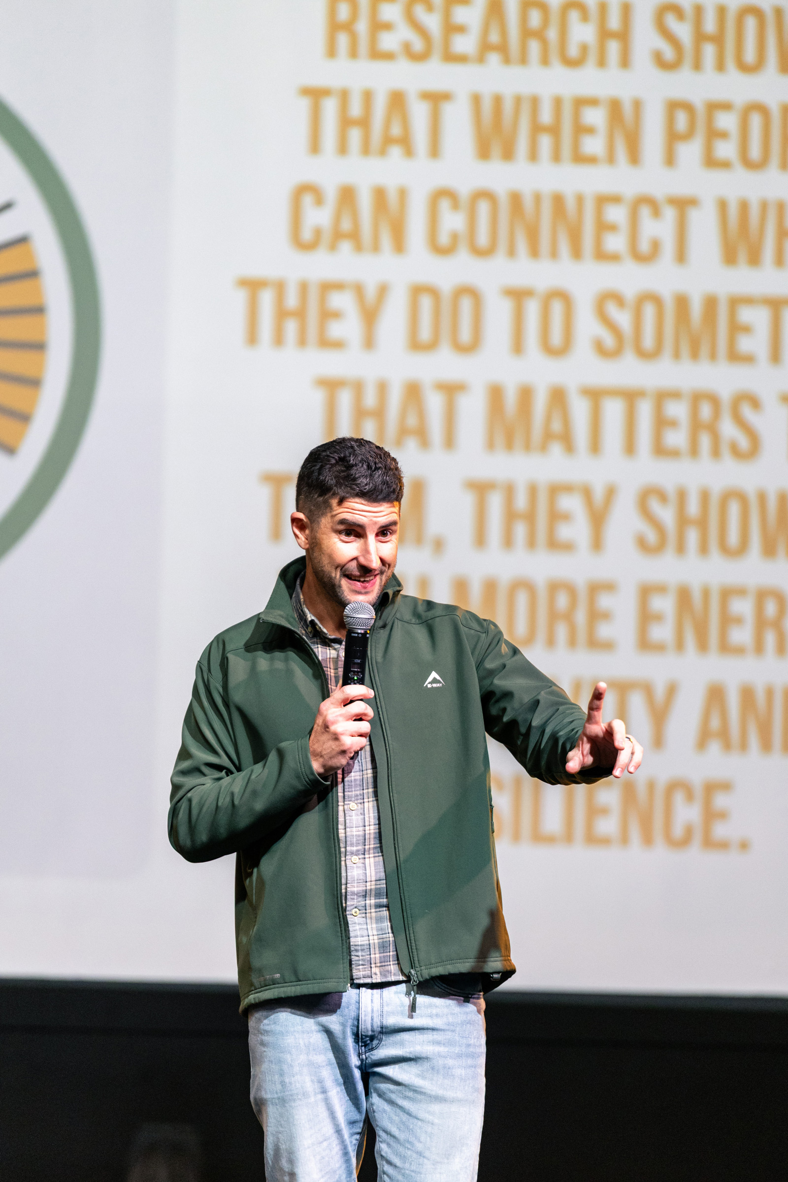 Man speaking on stage at a restory business event.