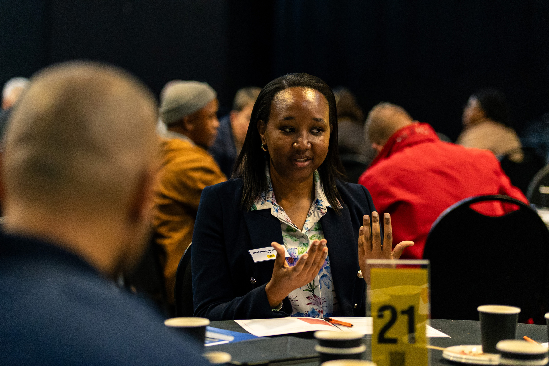 Woman speaks at a restory business table discussion.