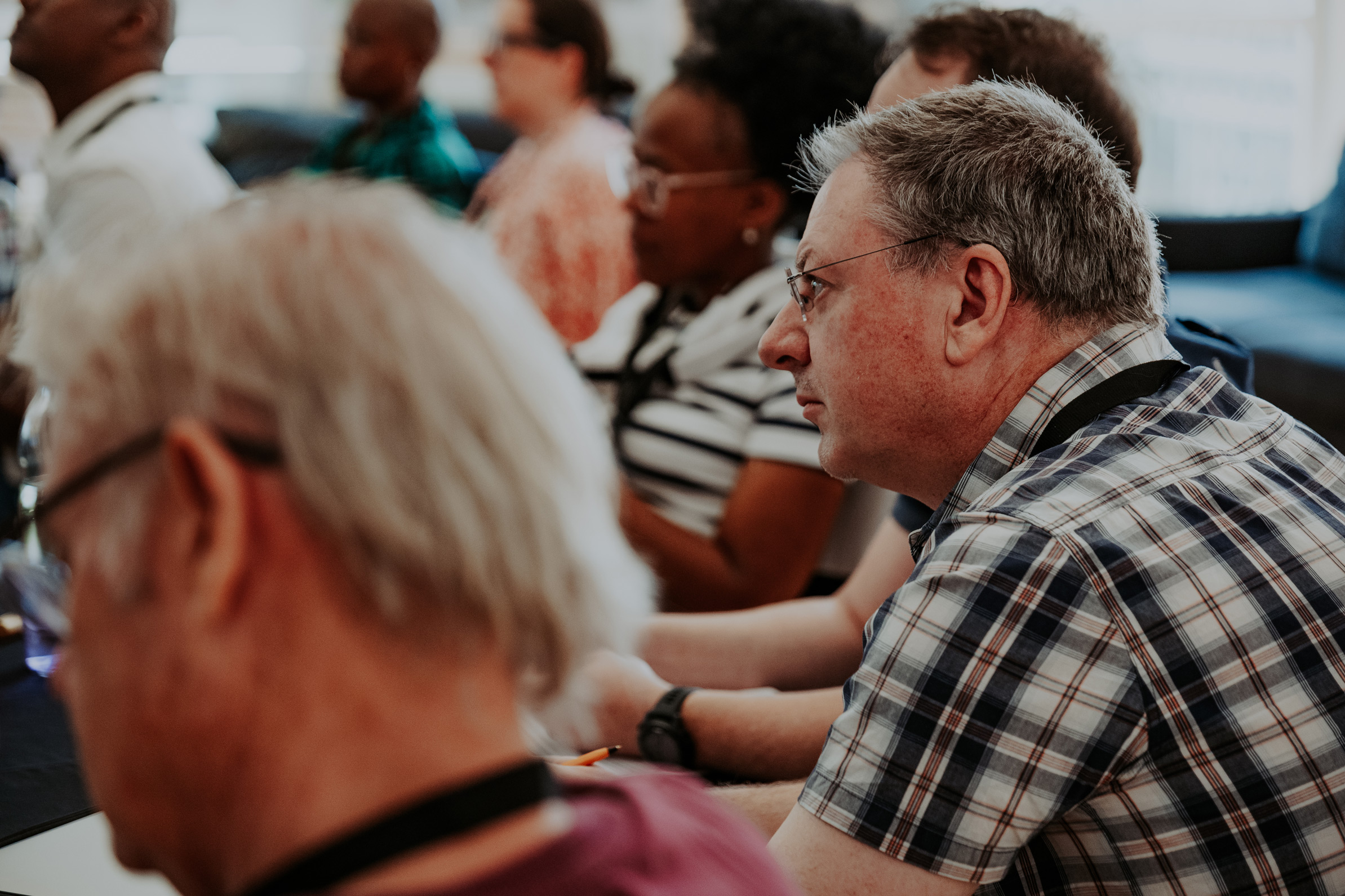 Man listening to the speaker at a restory business journey session.