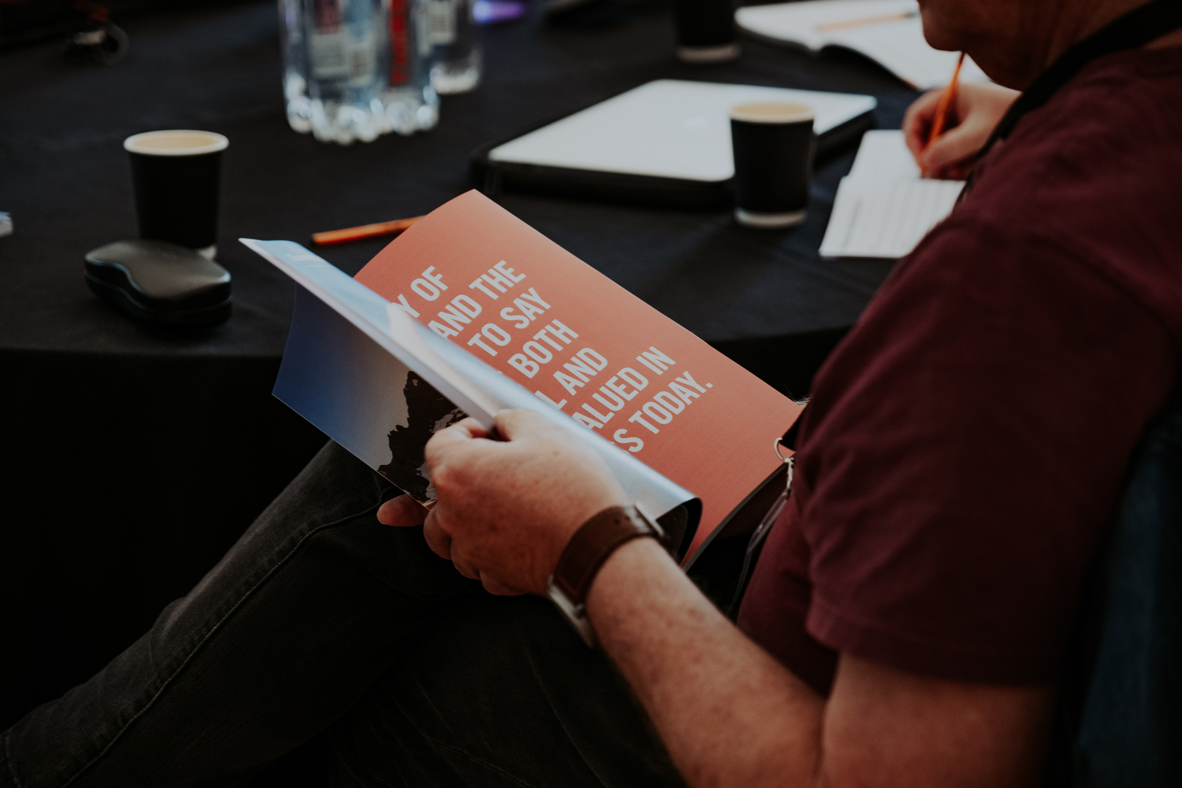 Man reading a workbook at a restory business journey session.
