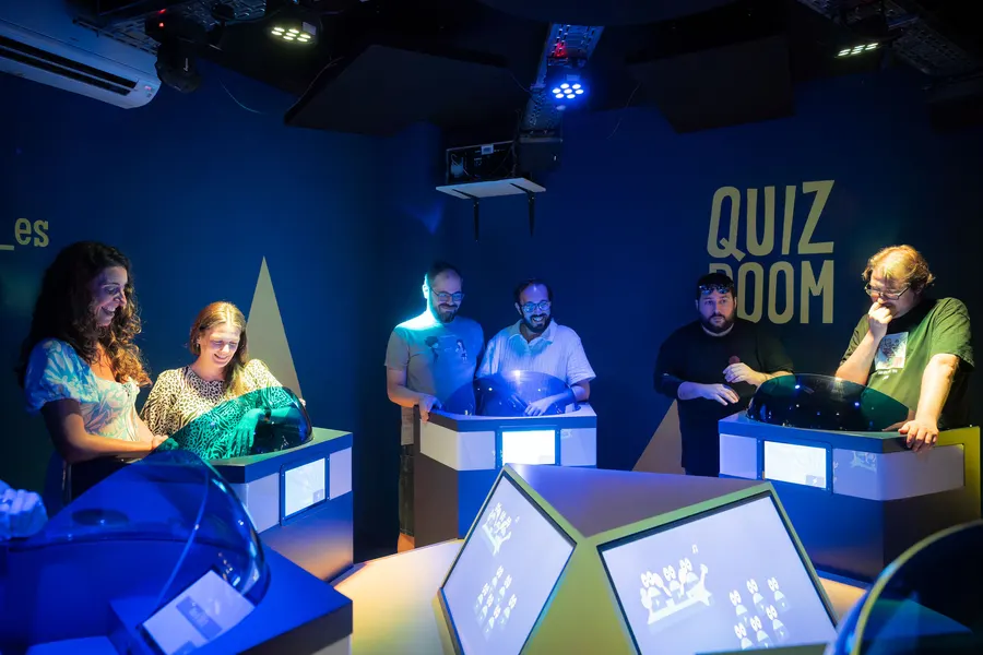 Groep vrienden geniet van teamquiz avond met bbuzzers
