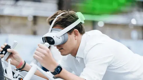Man wearing virtual reality headset and interacting with a device using hand controllers.