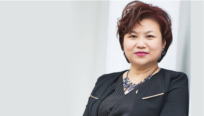 Stylish woman wearing black blazer and sporting short hair.