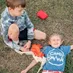 A couple of kids sitting on top of a chair.