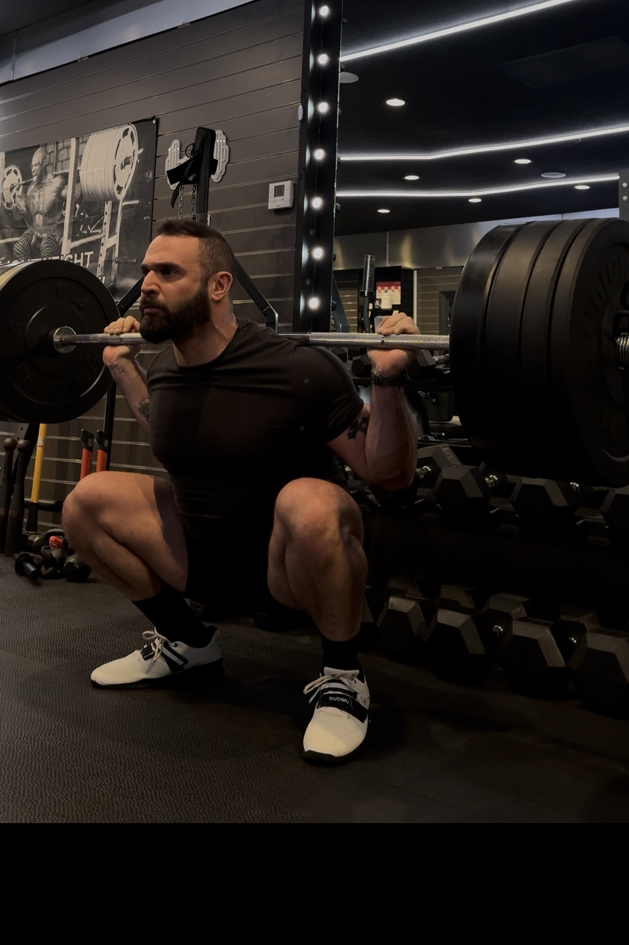 Joe El Khechef performing a heavily loaded back squat at Thrive Strength & Performance in Costa Mesa.