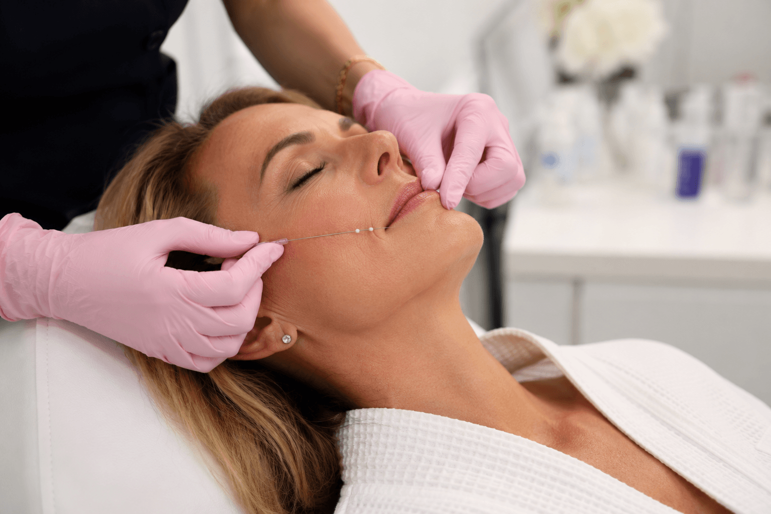 Provider performing a non-surgical thread lift treatment to improve jawline definition and facial contours at a medspa in Charlotte, North Carolina.