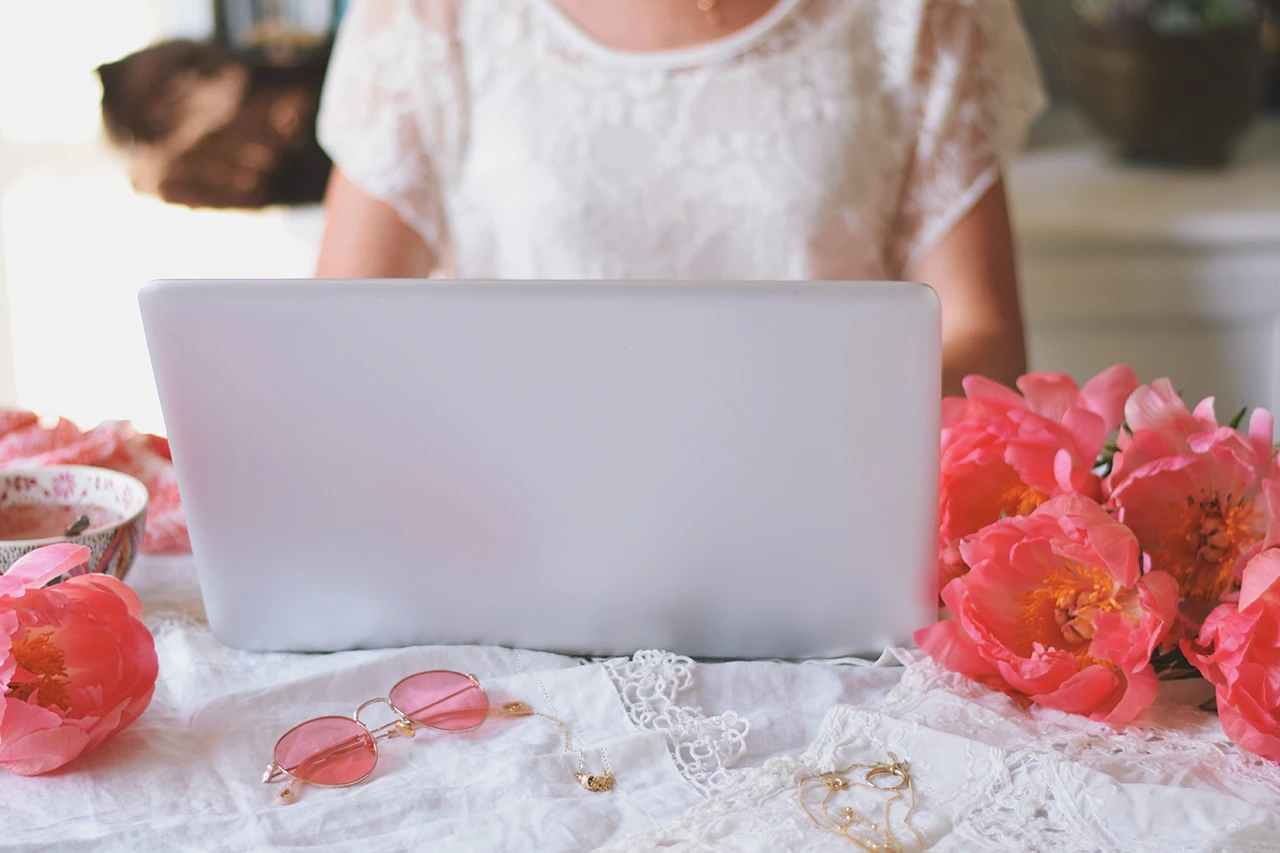 Bride checking wedding makeup artist cost on laptop.