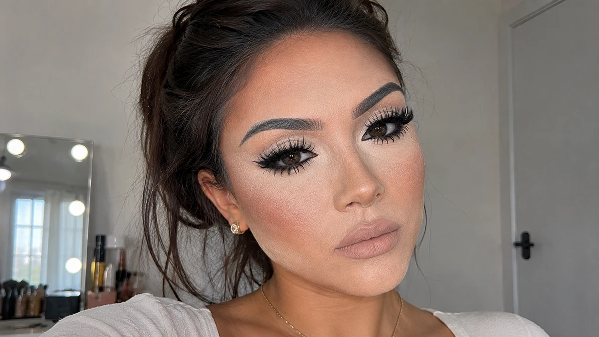 Beautiful woman wearing very cakey makeup.
