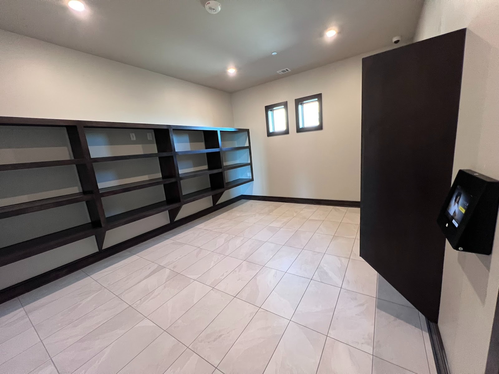 Person uses a smartphone app to unlock a smart access system, demonstrating how smart lockers or property entry work.