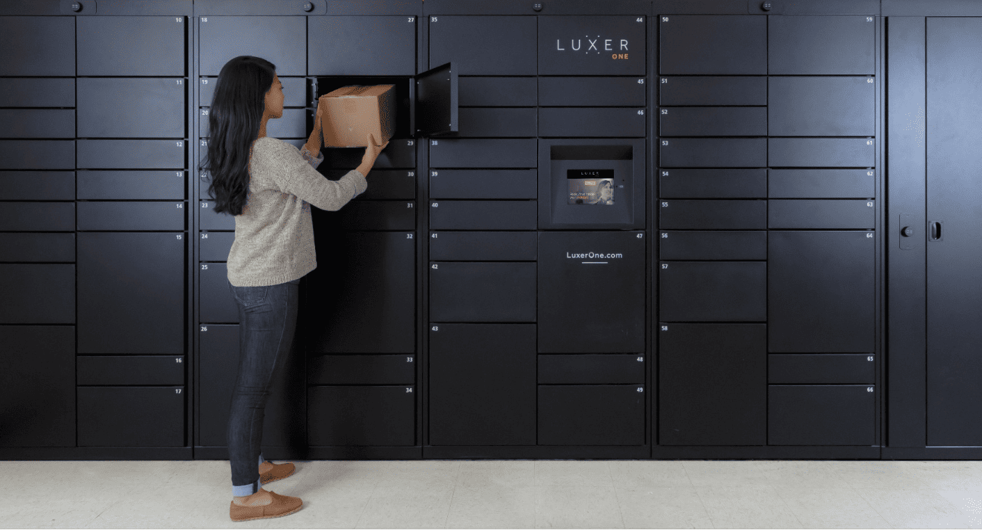 Person uses a smartphone app to unlock a smart access system, demonstrating how smart lockers or property entry work.