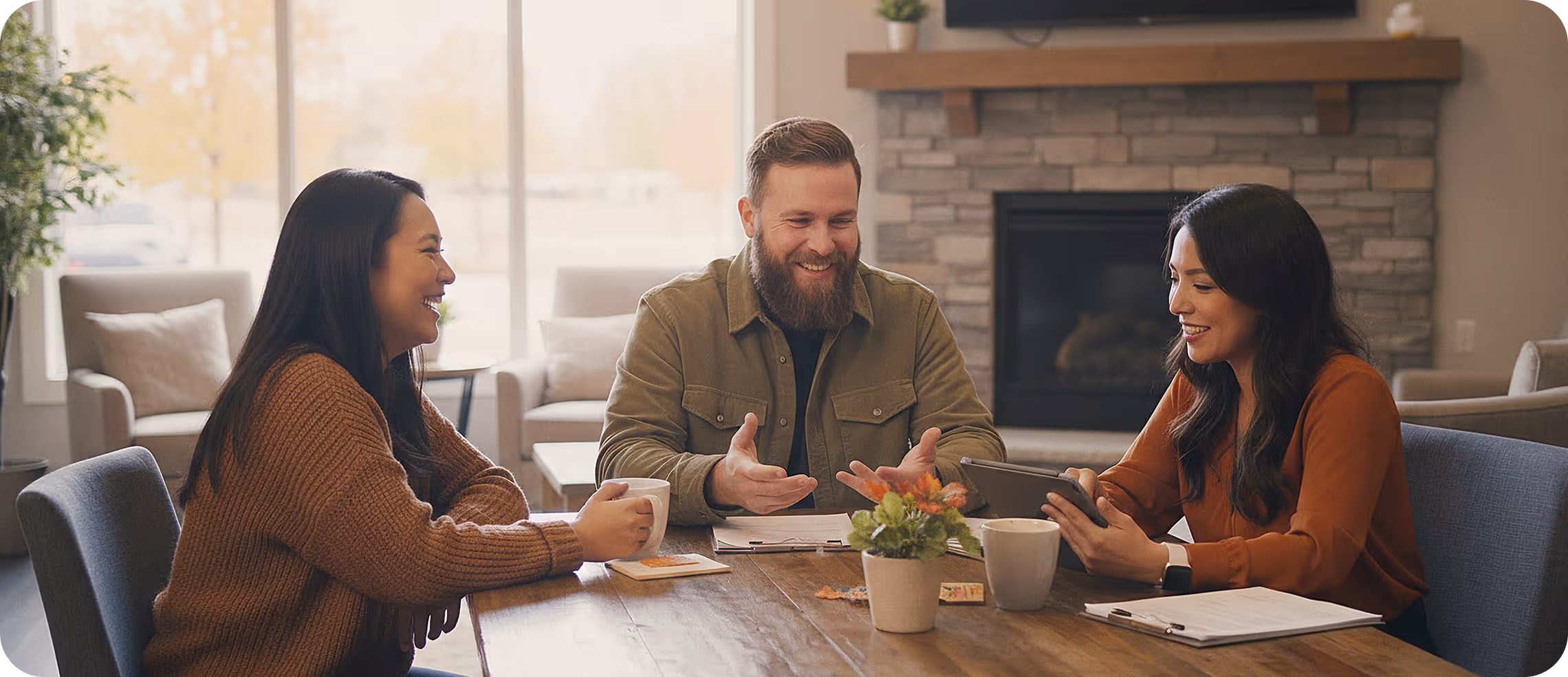 Smiling employees around a table