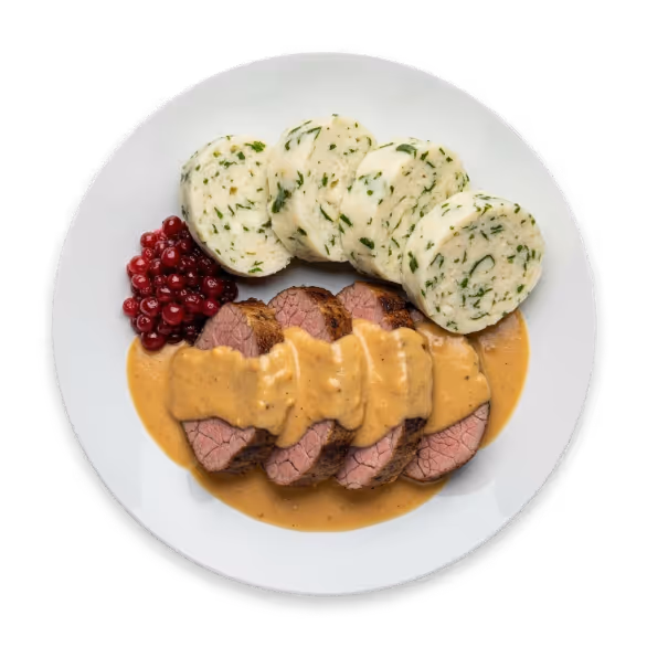Sliced roast beef with creamy brown gravy, round herb dumplings, and a serving of red lingonberries on a white plate.