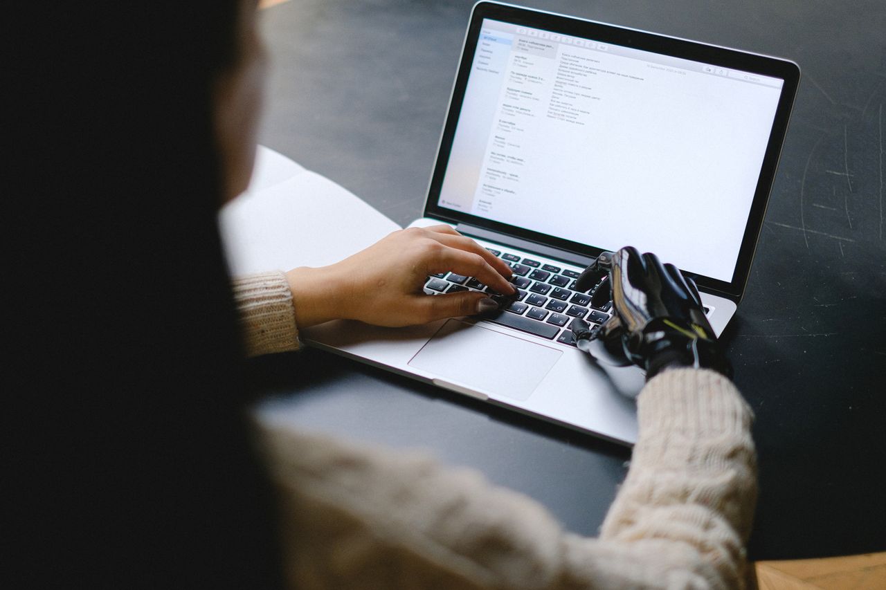 Human and AI collaborating on a laptop to support email personalization, customer communication, and marketing workflow optimization.