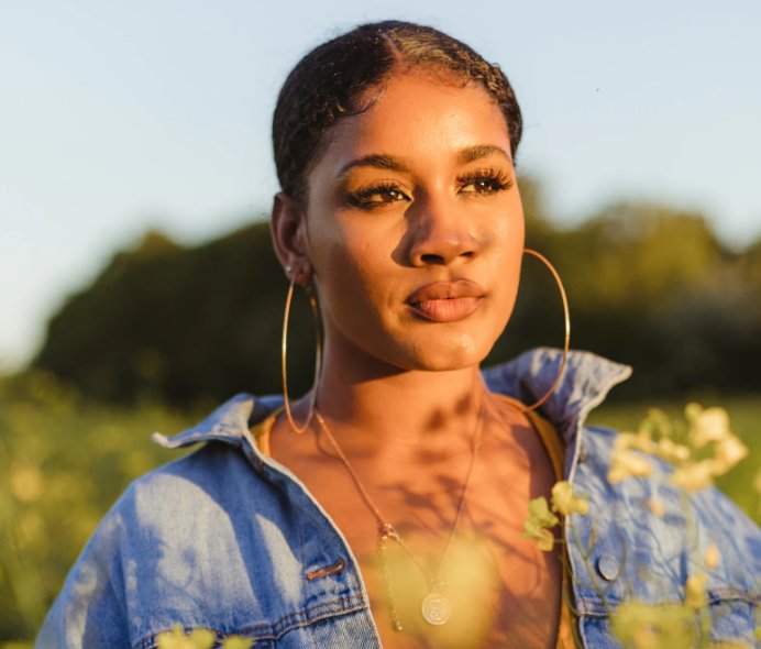 Woman in a field of flower looking out. 