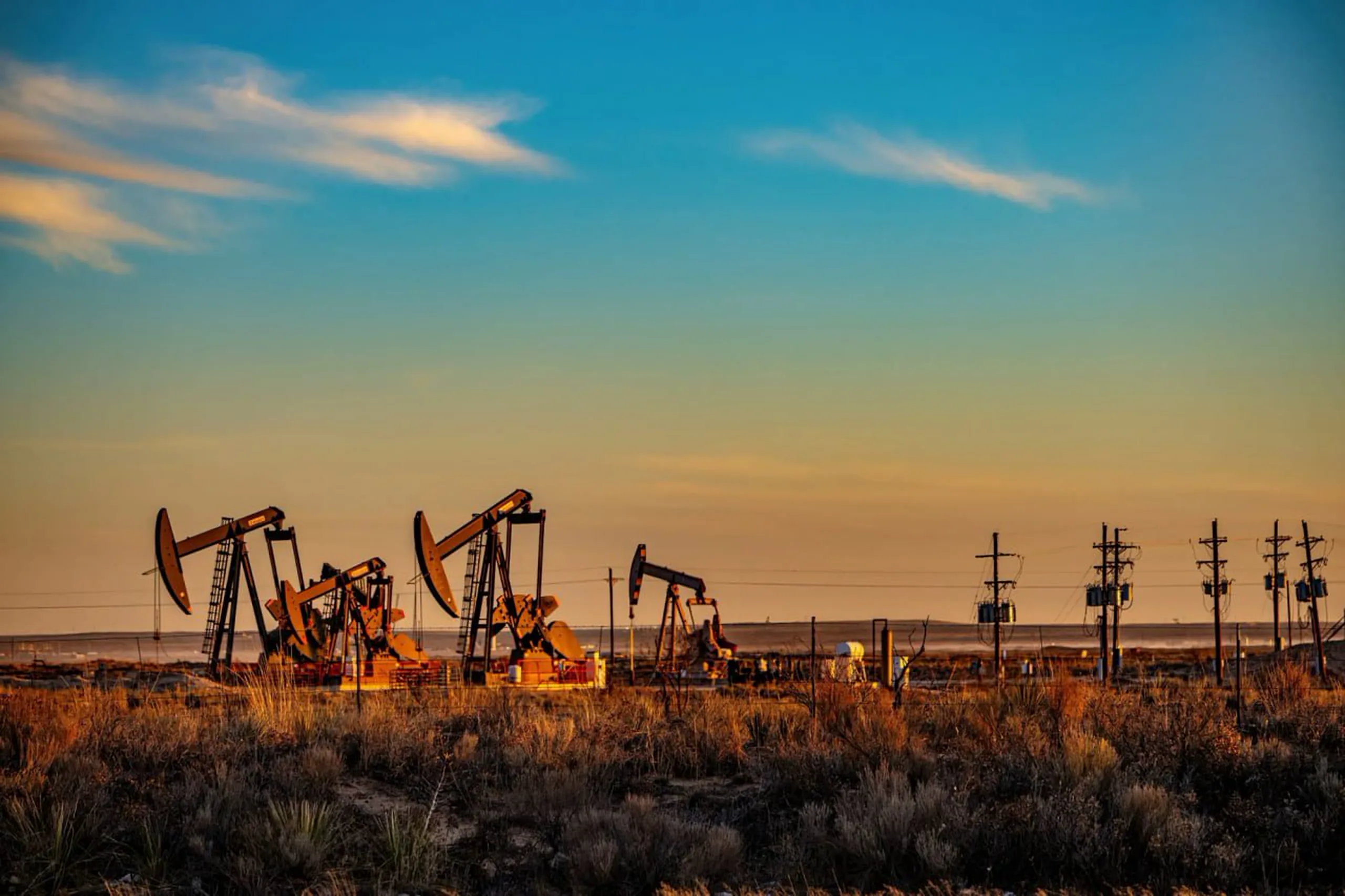 Pumpjacks operating in a New Mexico oil field at sunset