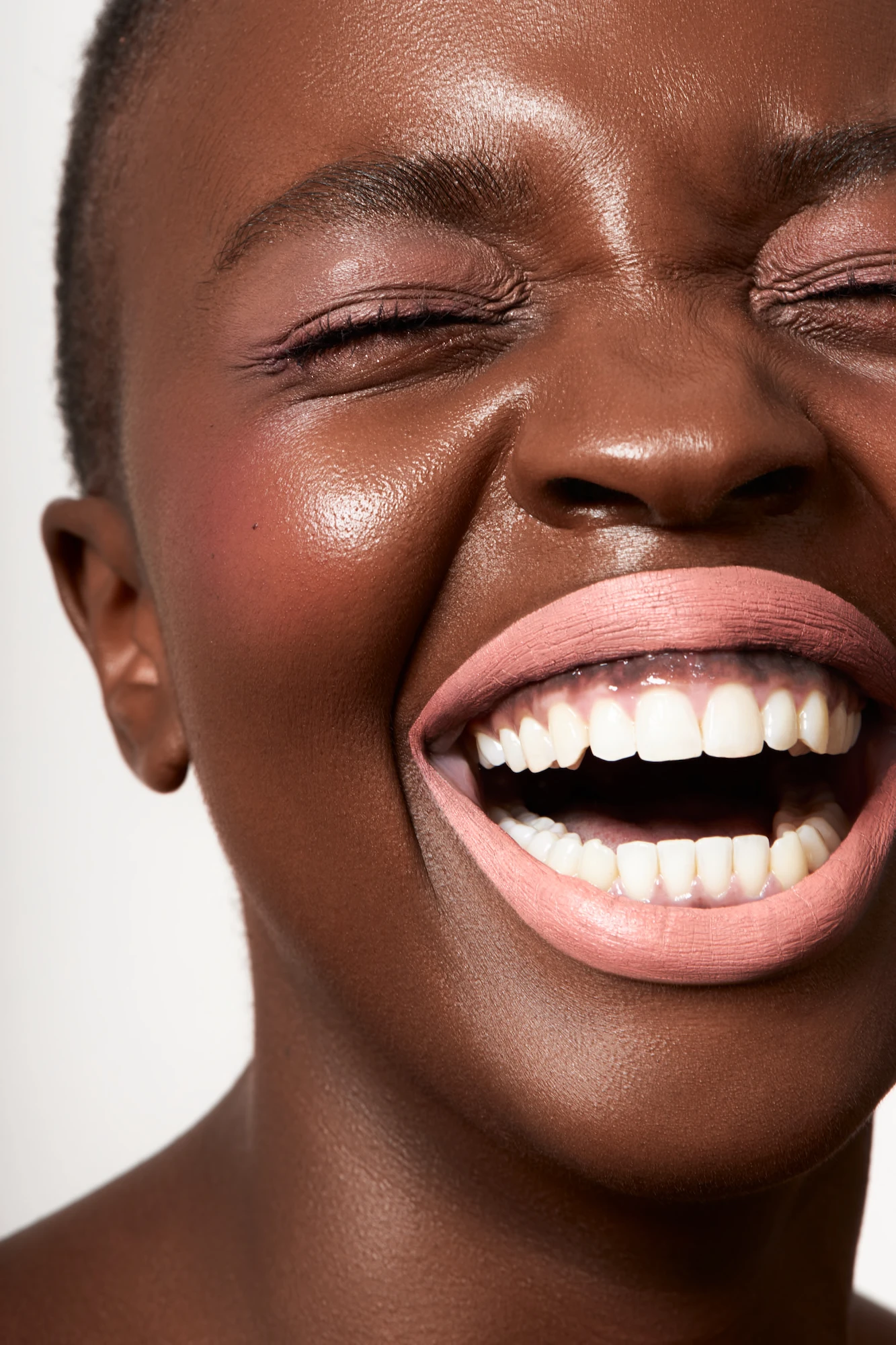 A woman with a pink lipstick smile.