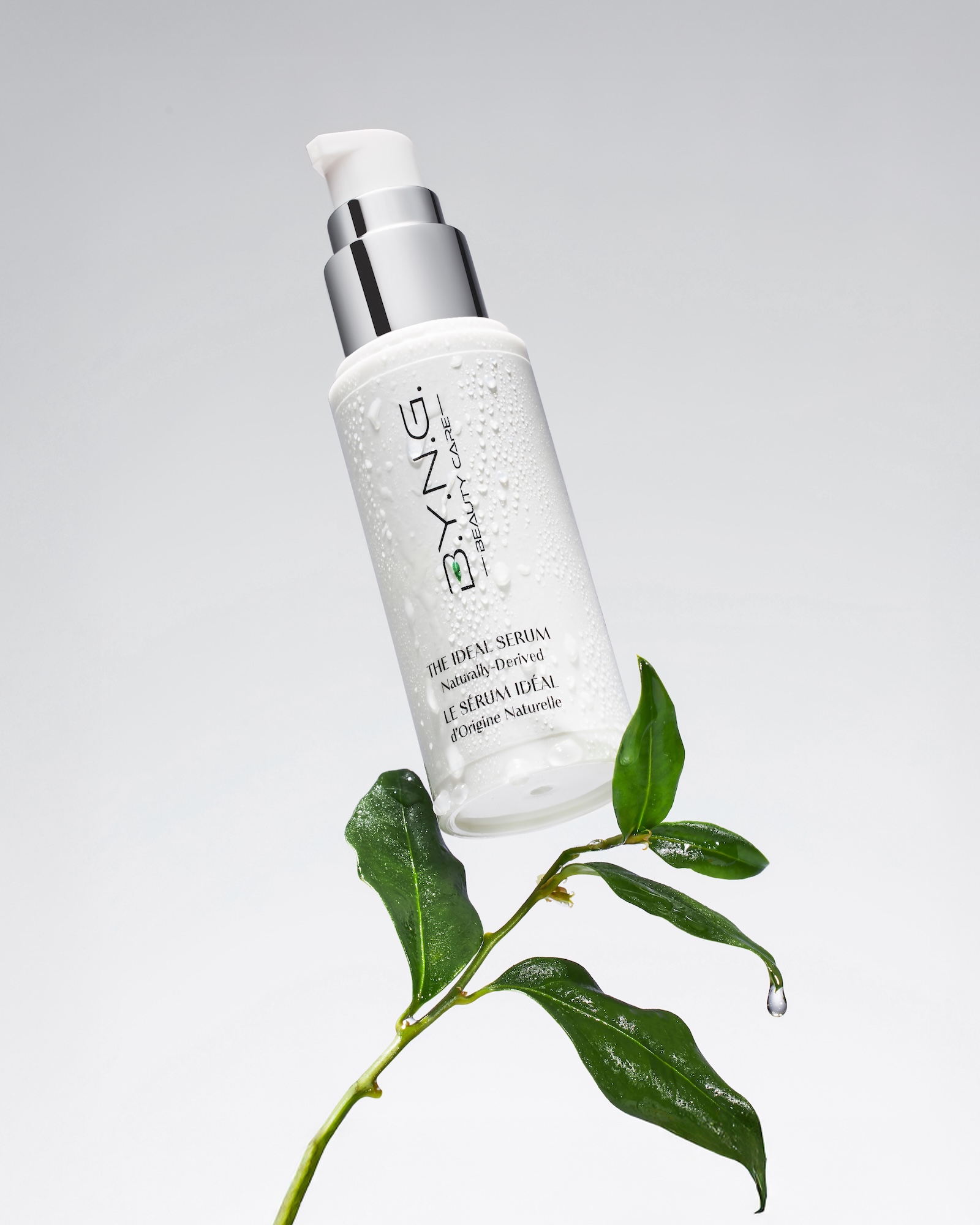 A bottle of water with a green leaf on top.