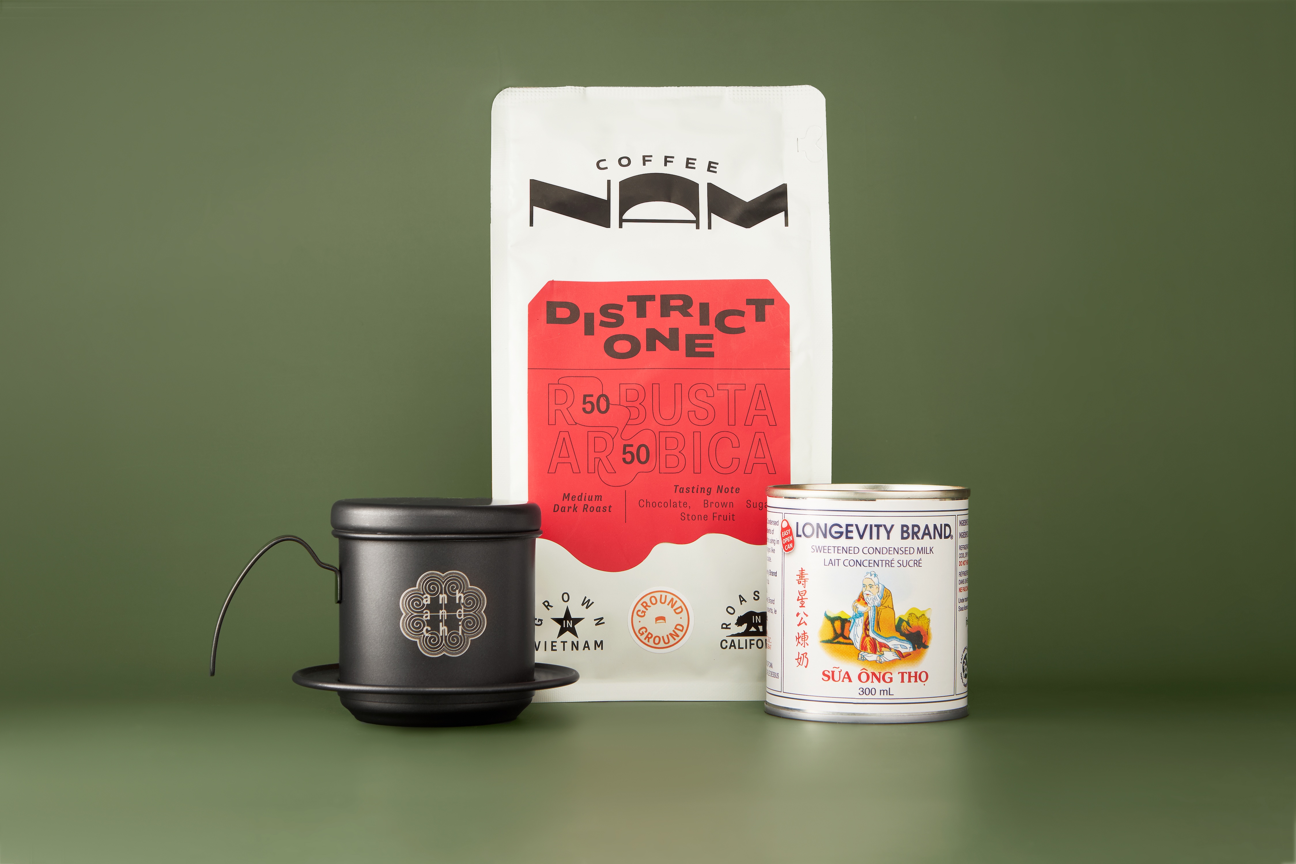 A bag of coffee sits on a table next to a can of coffee.