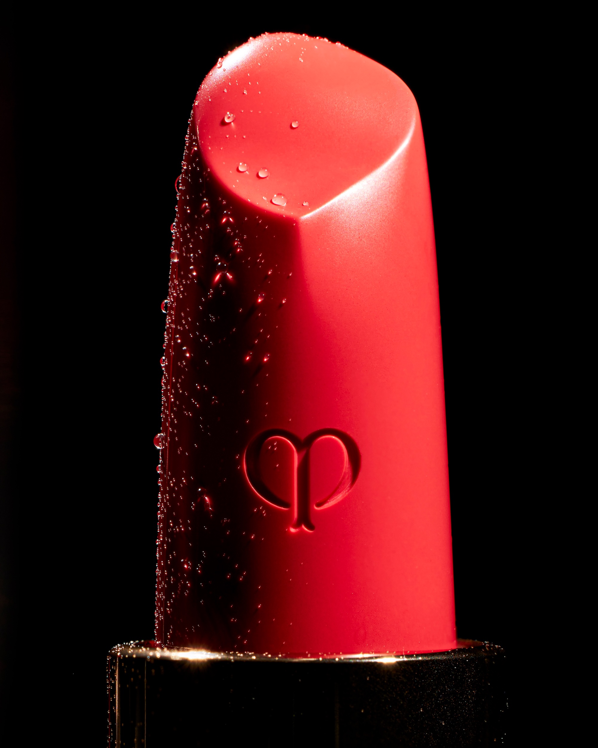 A red lipstick with a gold cap.