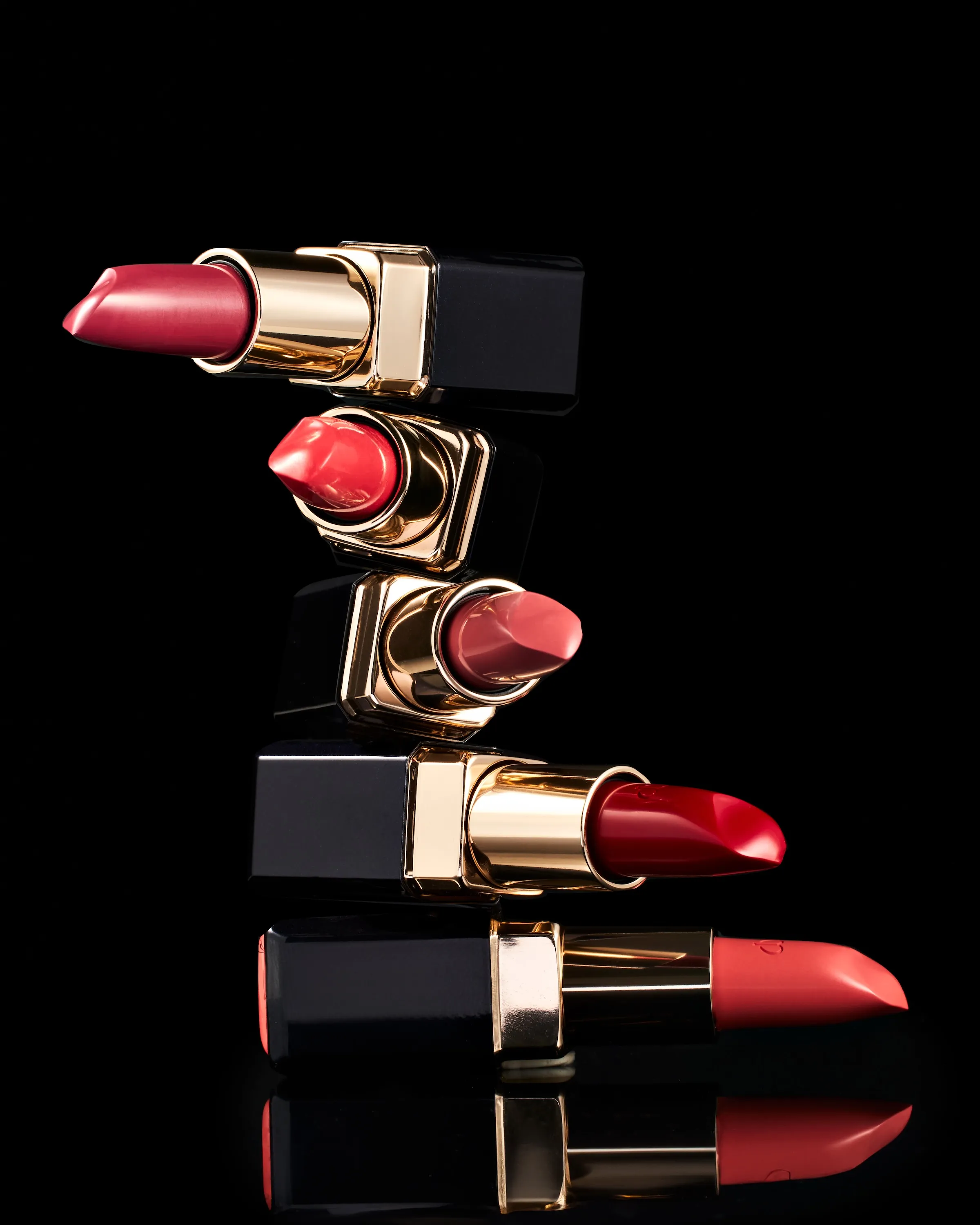 A row of lipsticks in a black case.