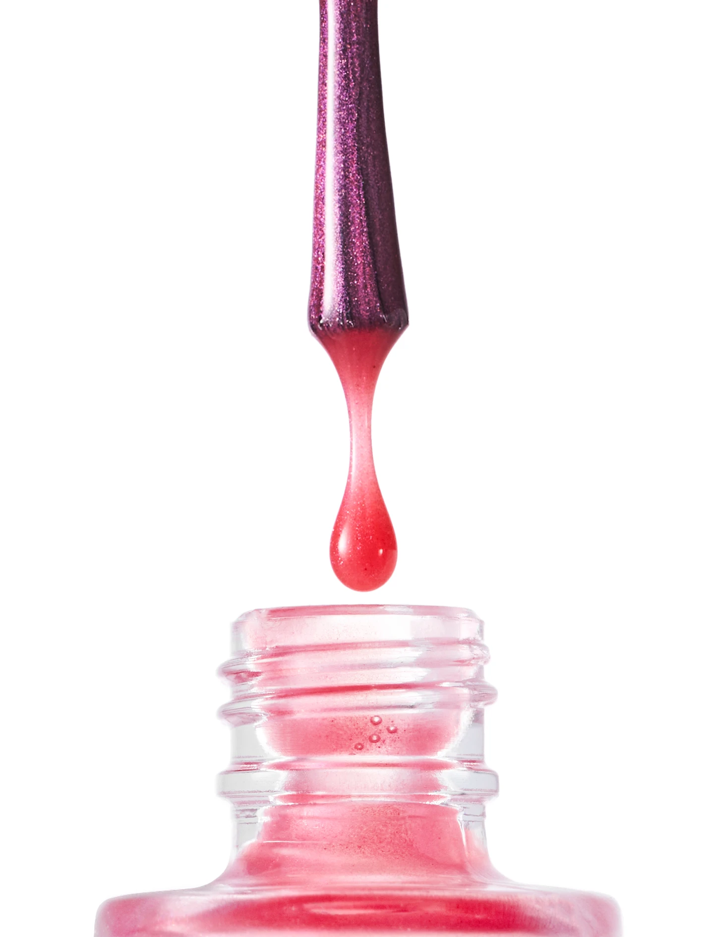 A bottle of pink nail polish with a purple brush.