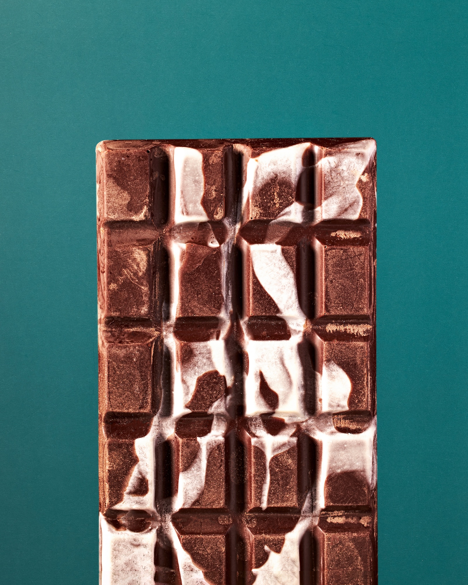 A close up of a chocolate bar with white cream.