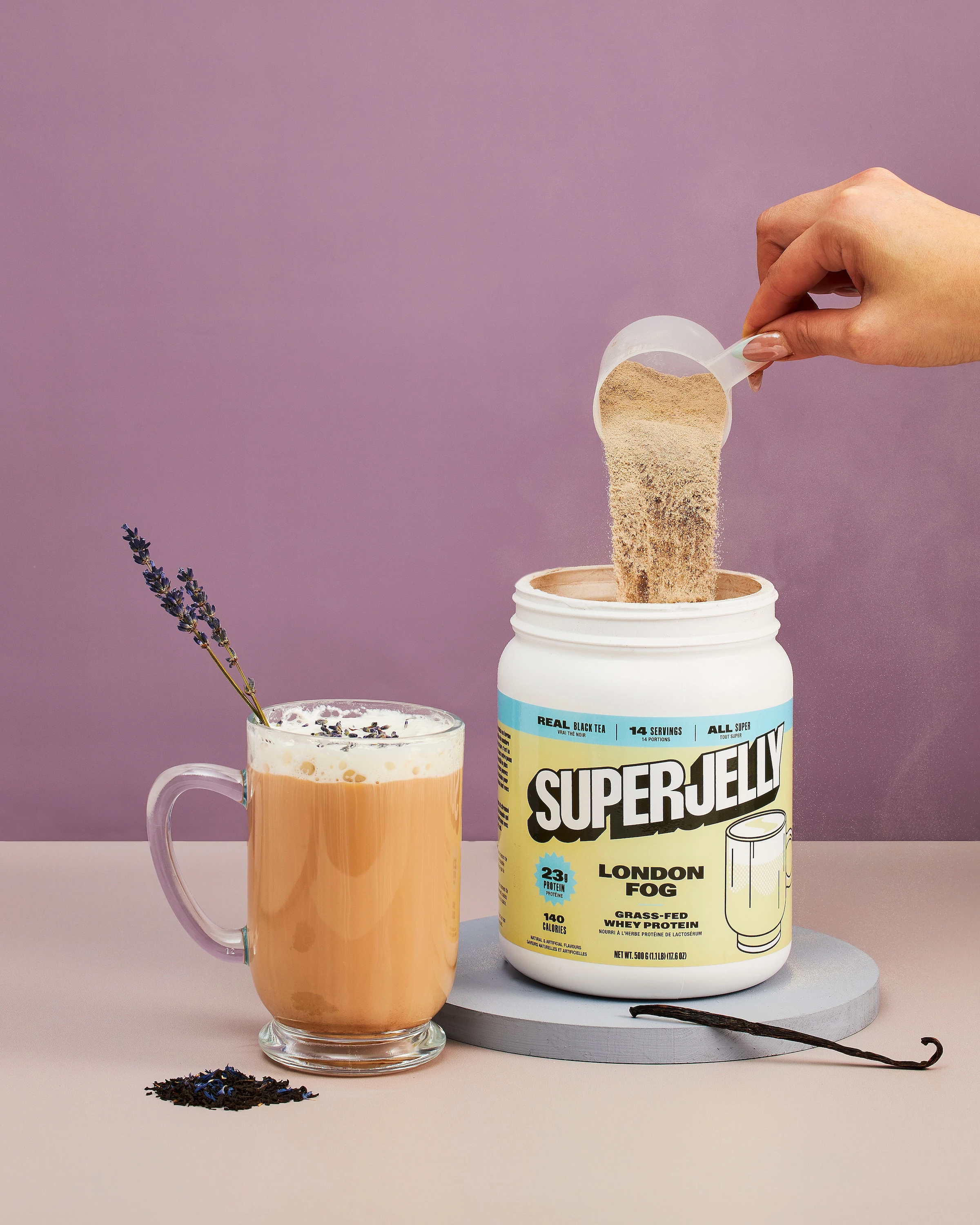 A person pouring a cup of coffee with a spoon in it.