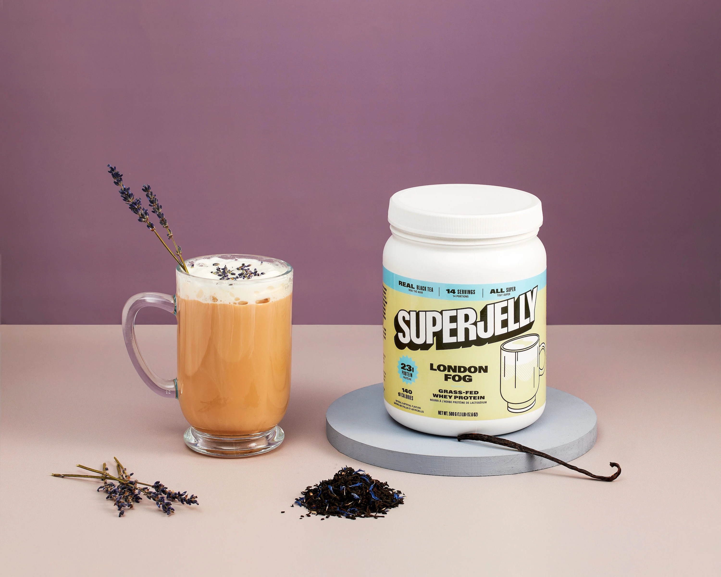 A glass of tea with a spoon in it.