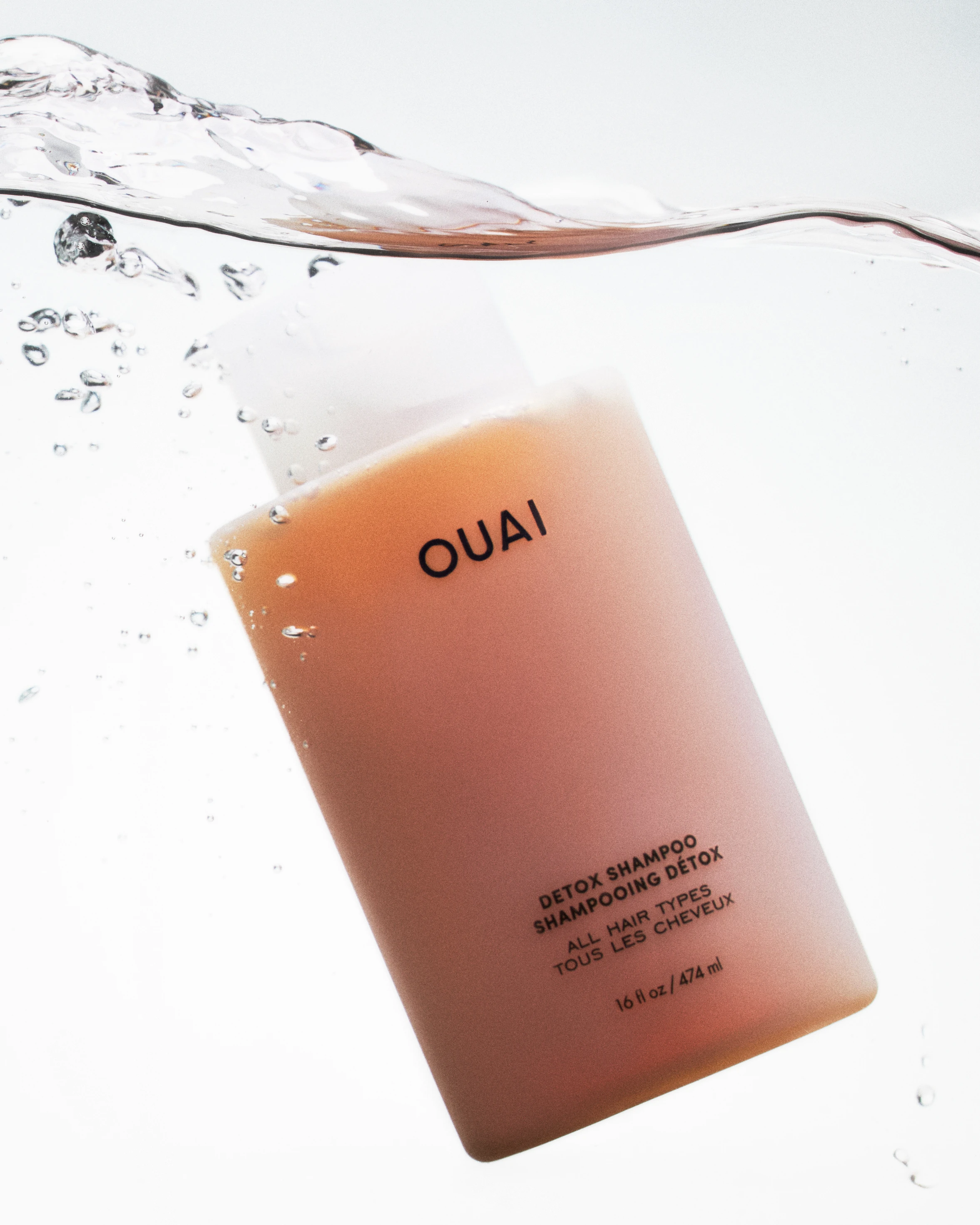 A bottle of Quai hair care product.