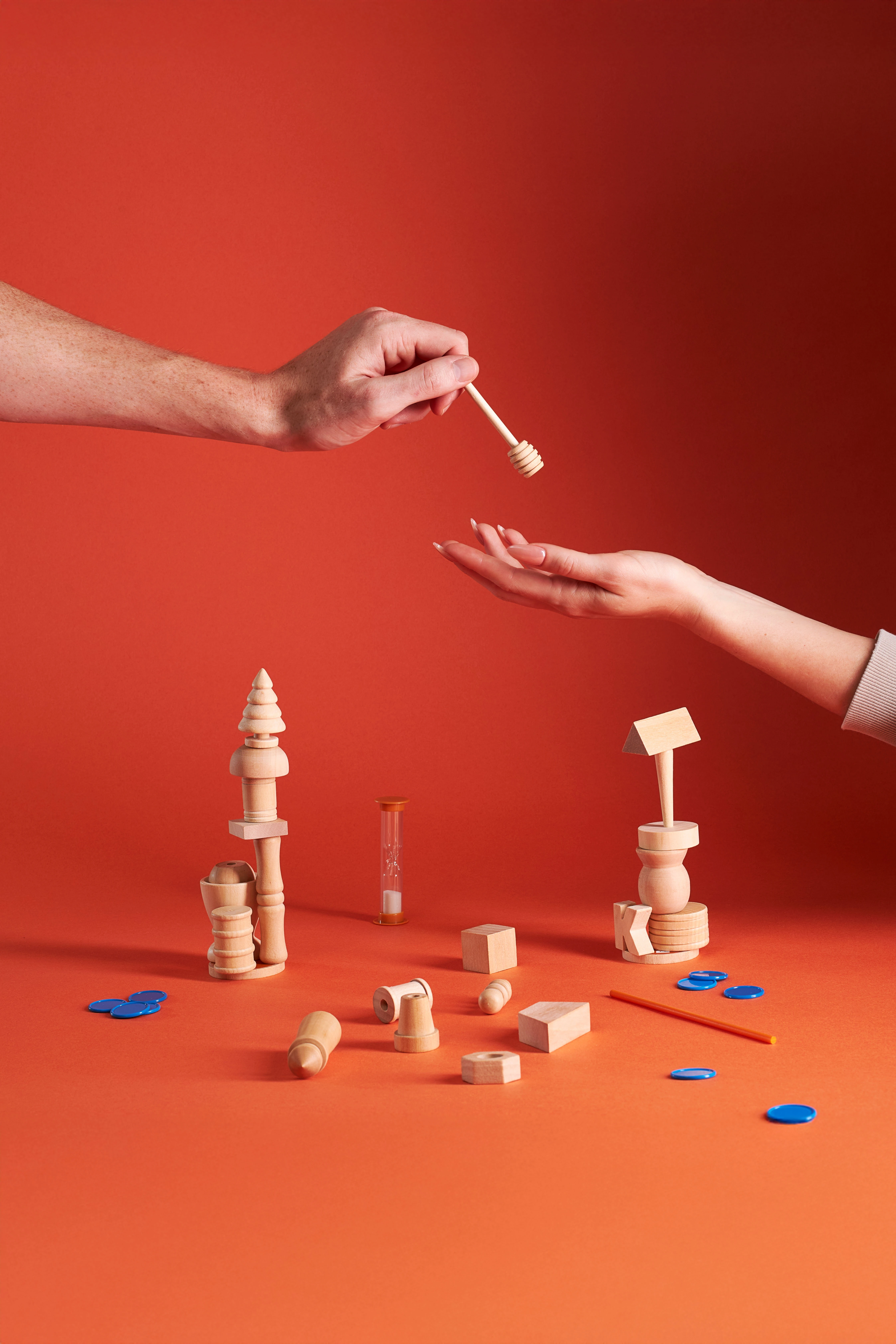 A woman is holding a toothbrush and a small toy from the Bloink Game