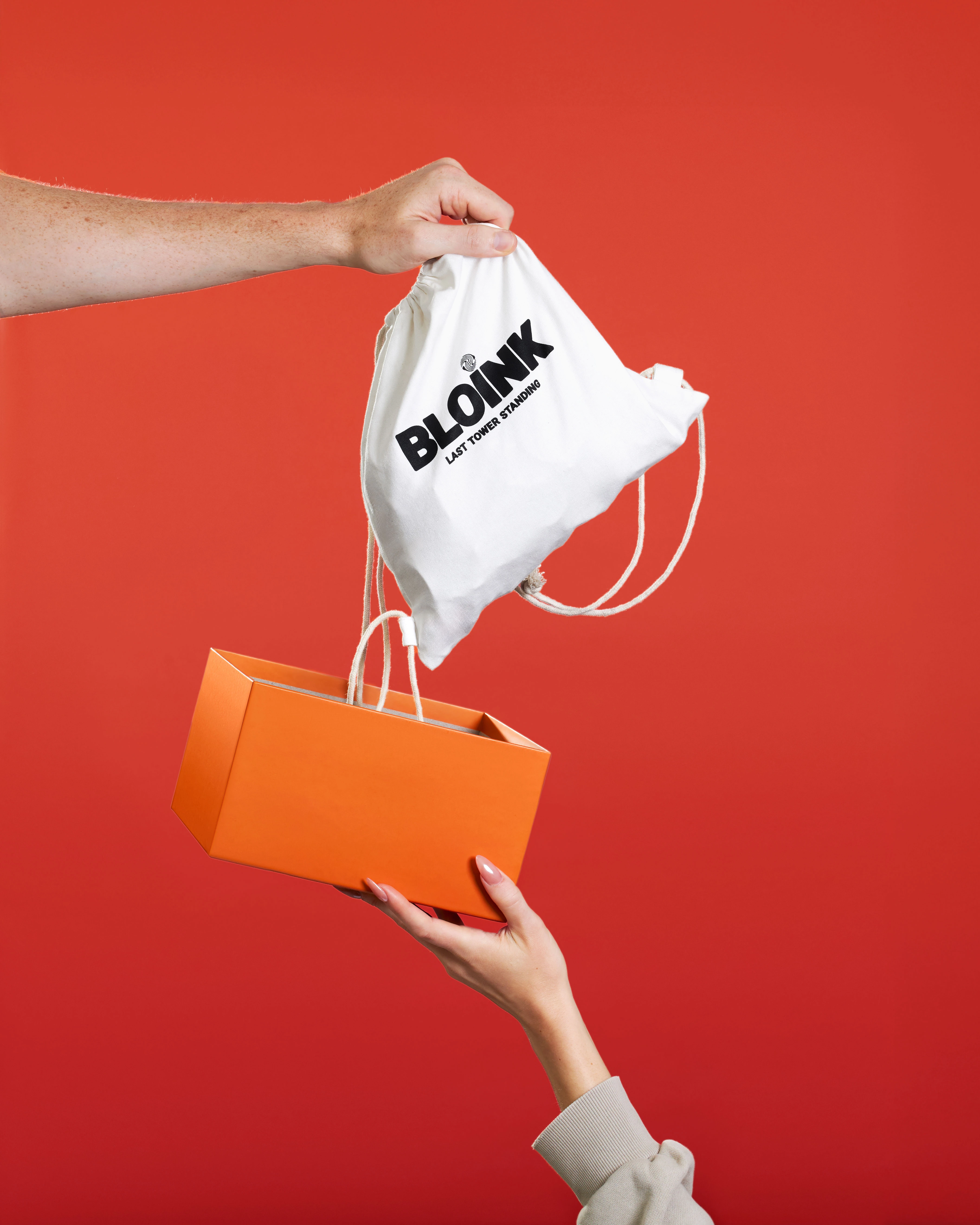 A person is holding a bag with Bloink Game.