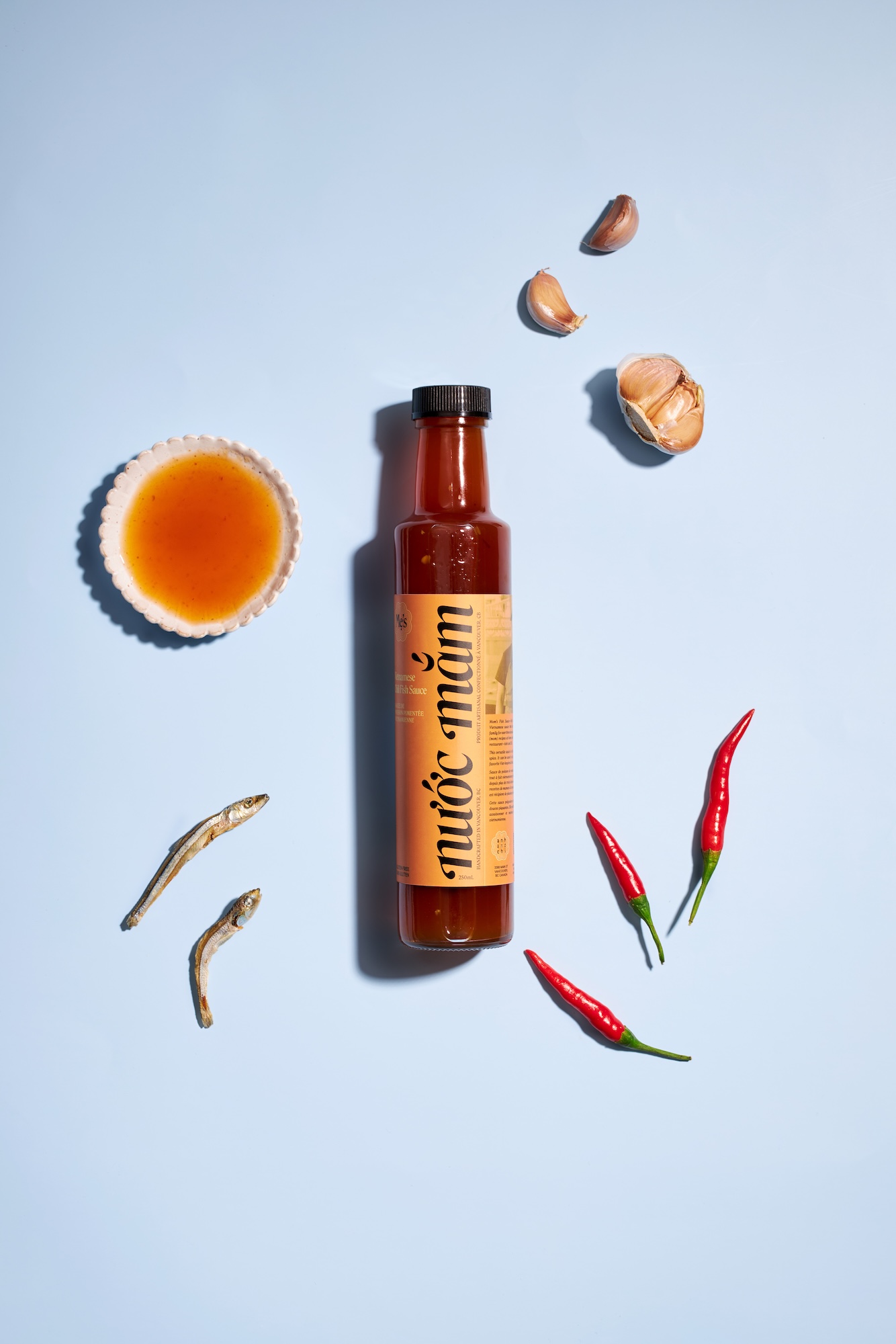 A bottle of Ahn and Chi sauce with a fish on the label.