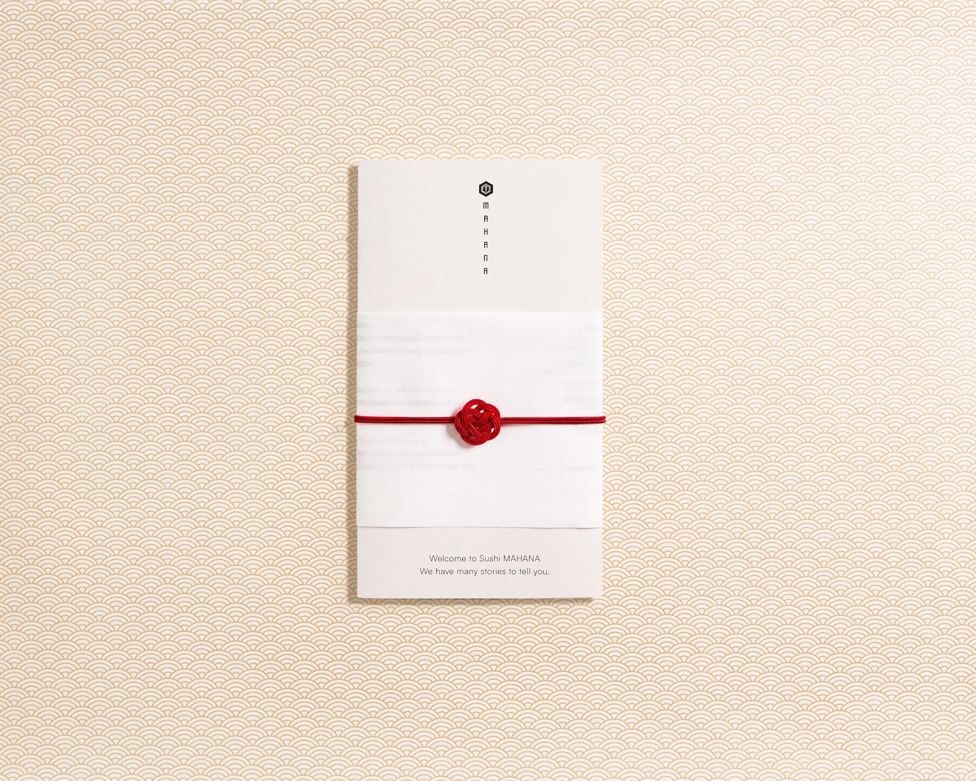 A white envelope with a red ribbon tied around it.