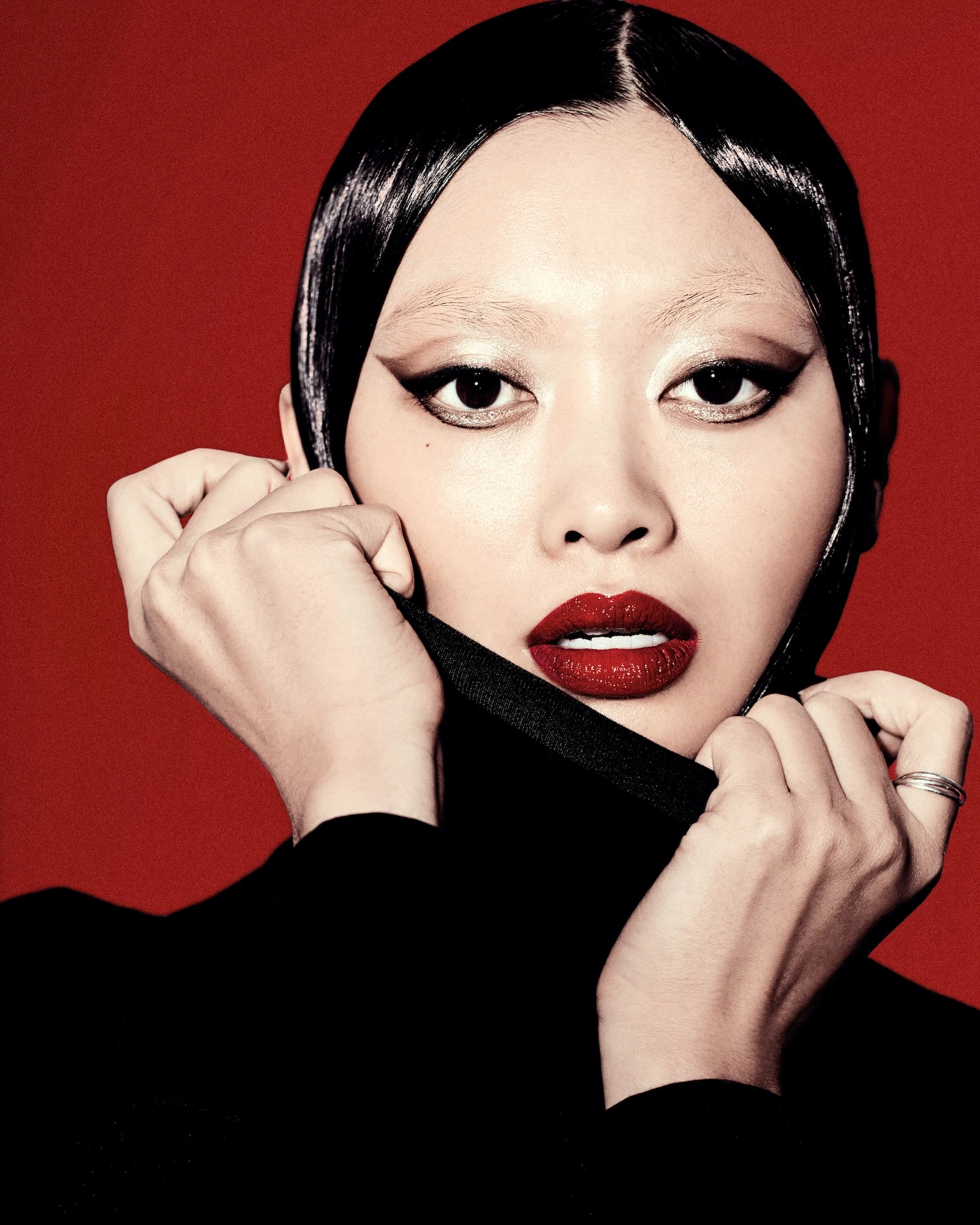 A woman with black hair and a black shirt.