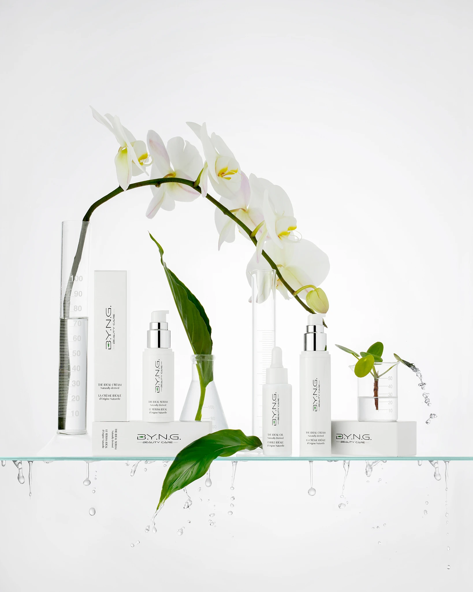 A bottle of Byng Cosmetics sits on a glass shelf.
