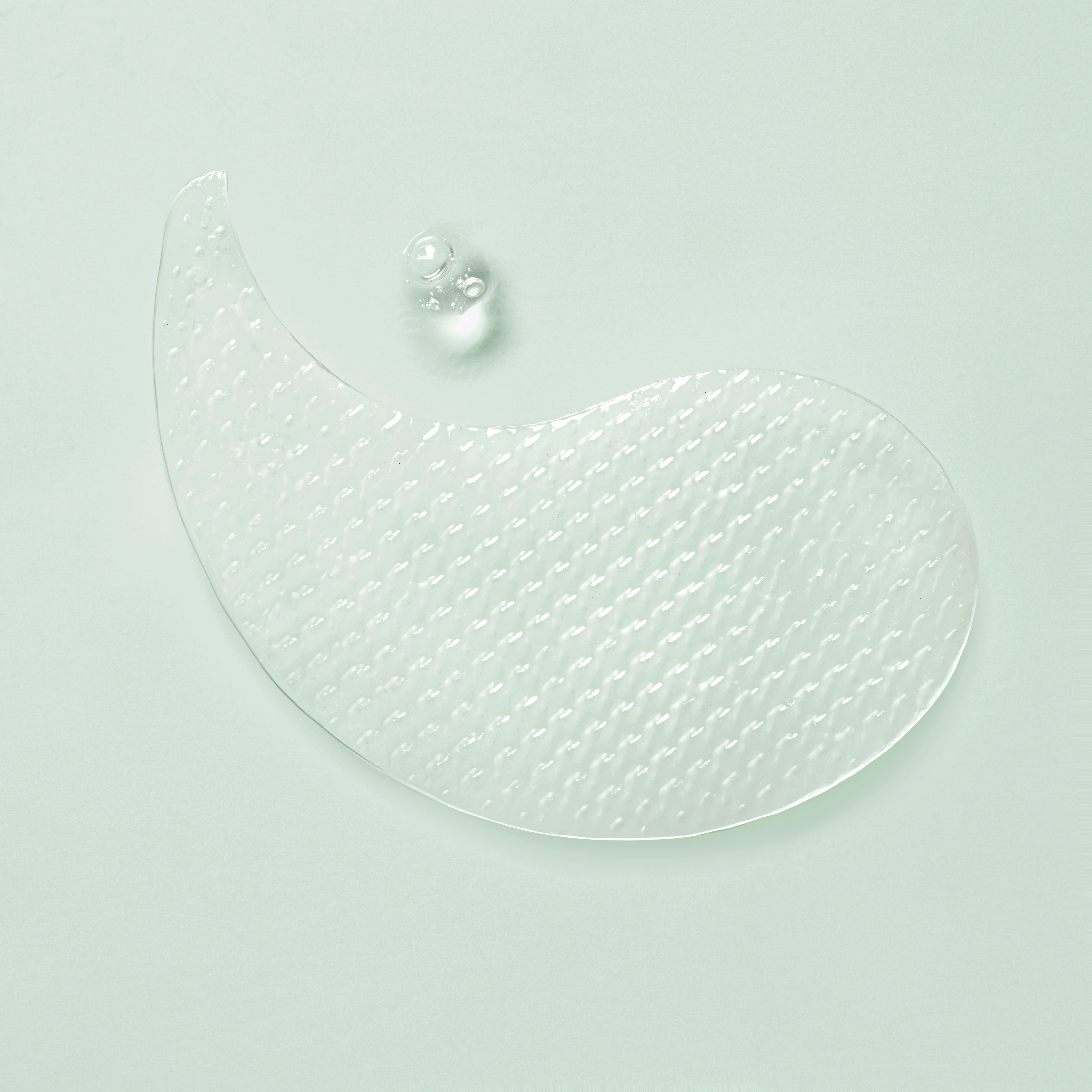 A clear glass with a pearl in the center.