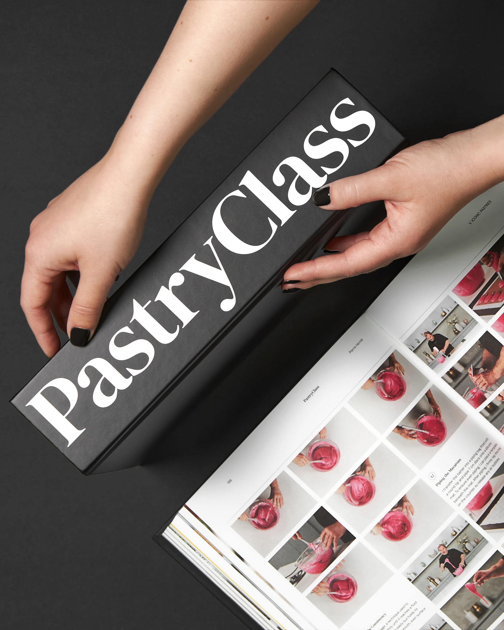 A person holding a Pastry Class book.