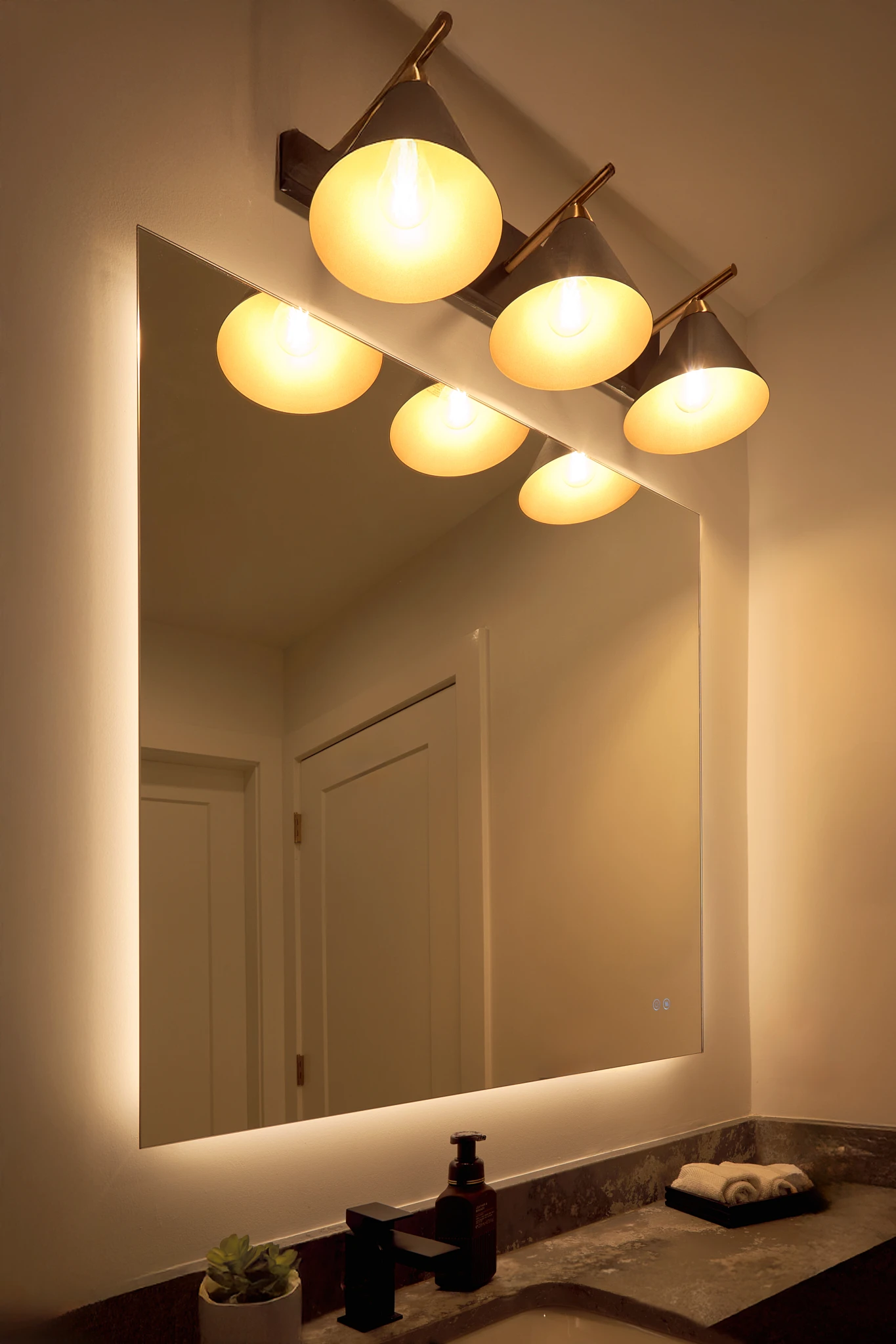 A bathroom mirror with lights on the sides.