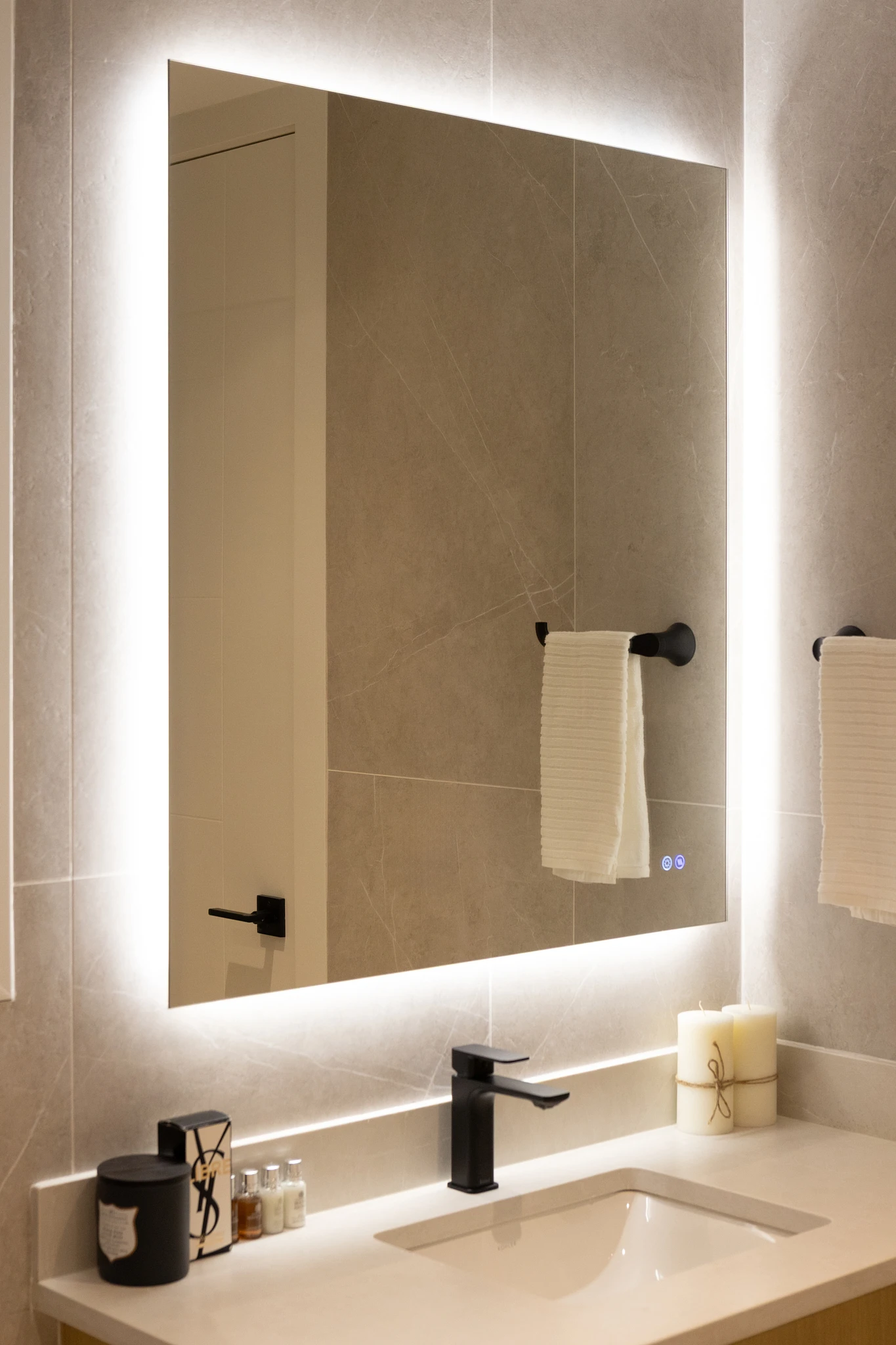 A bathroom with a mirror and a candle.