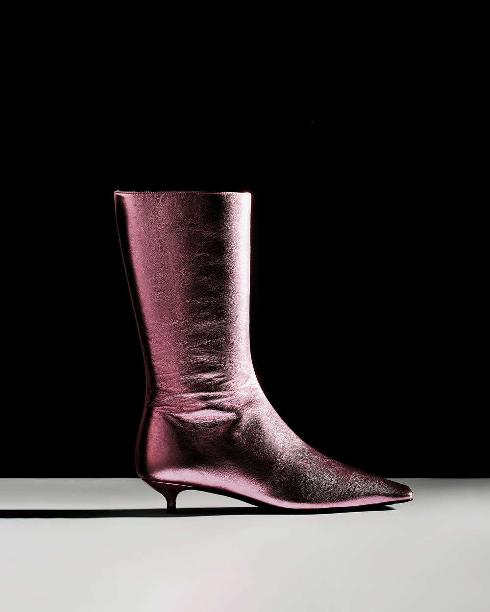 A purple boot with a black background.