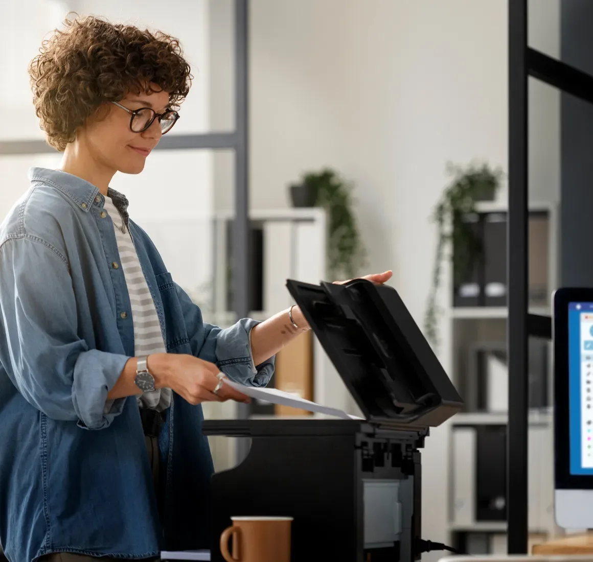 a woman scanning a document on an office copier