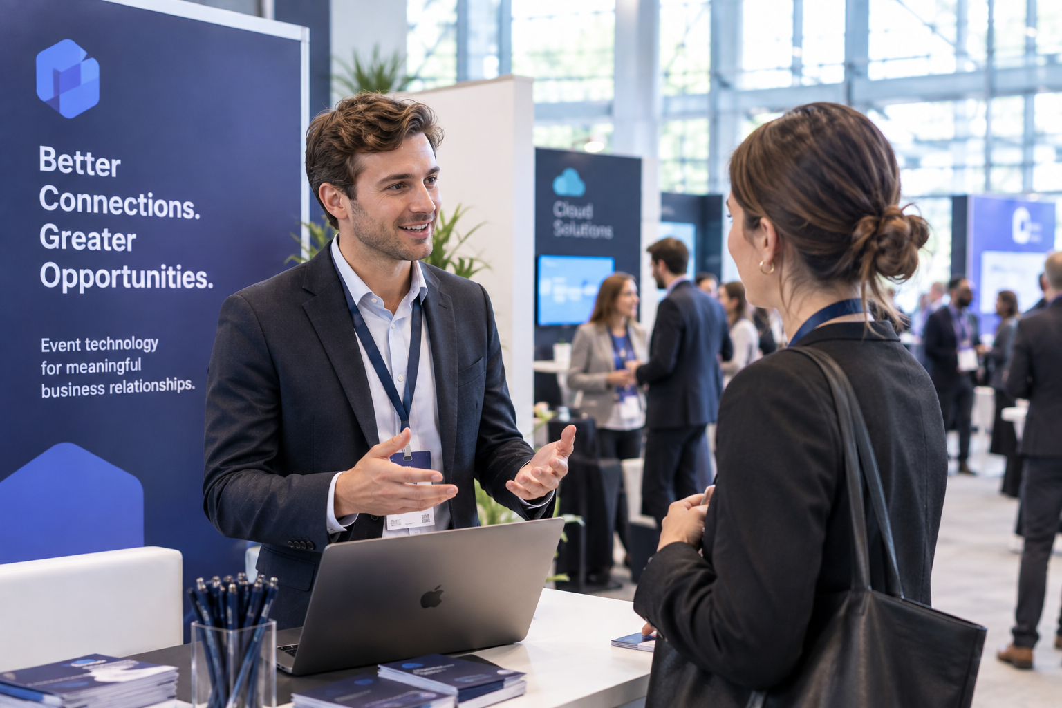 Exhibitor speaking with an attendee at a conference exhibition booth