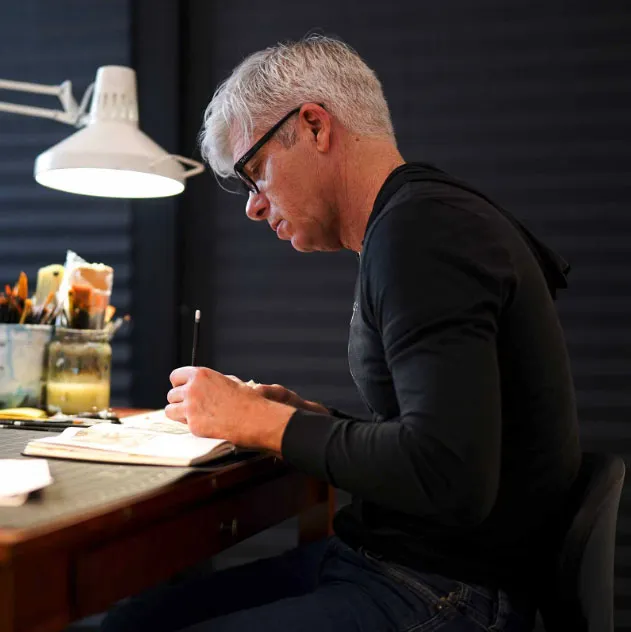 Marc Burckhardt drawing at his desk