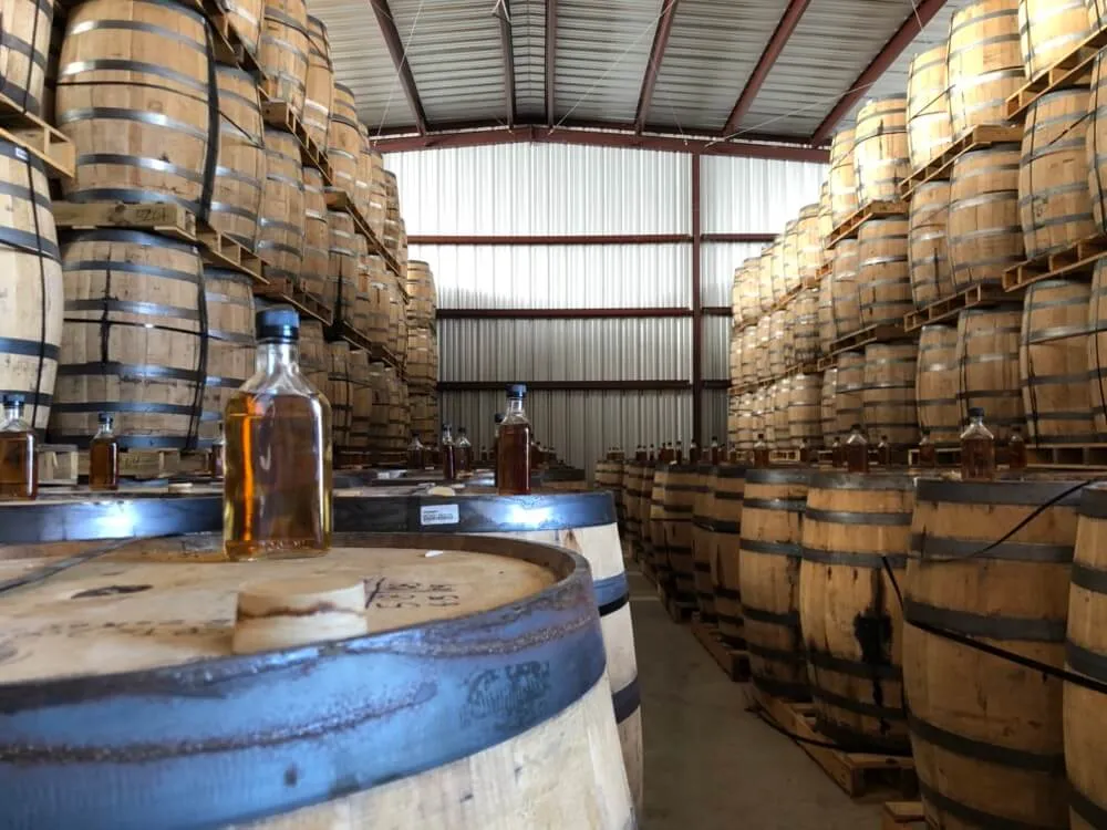 The cask room with sample bottles resting on barrel heads