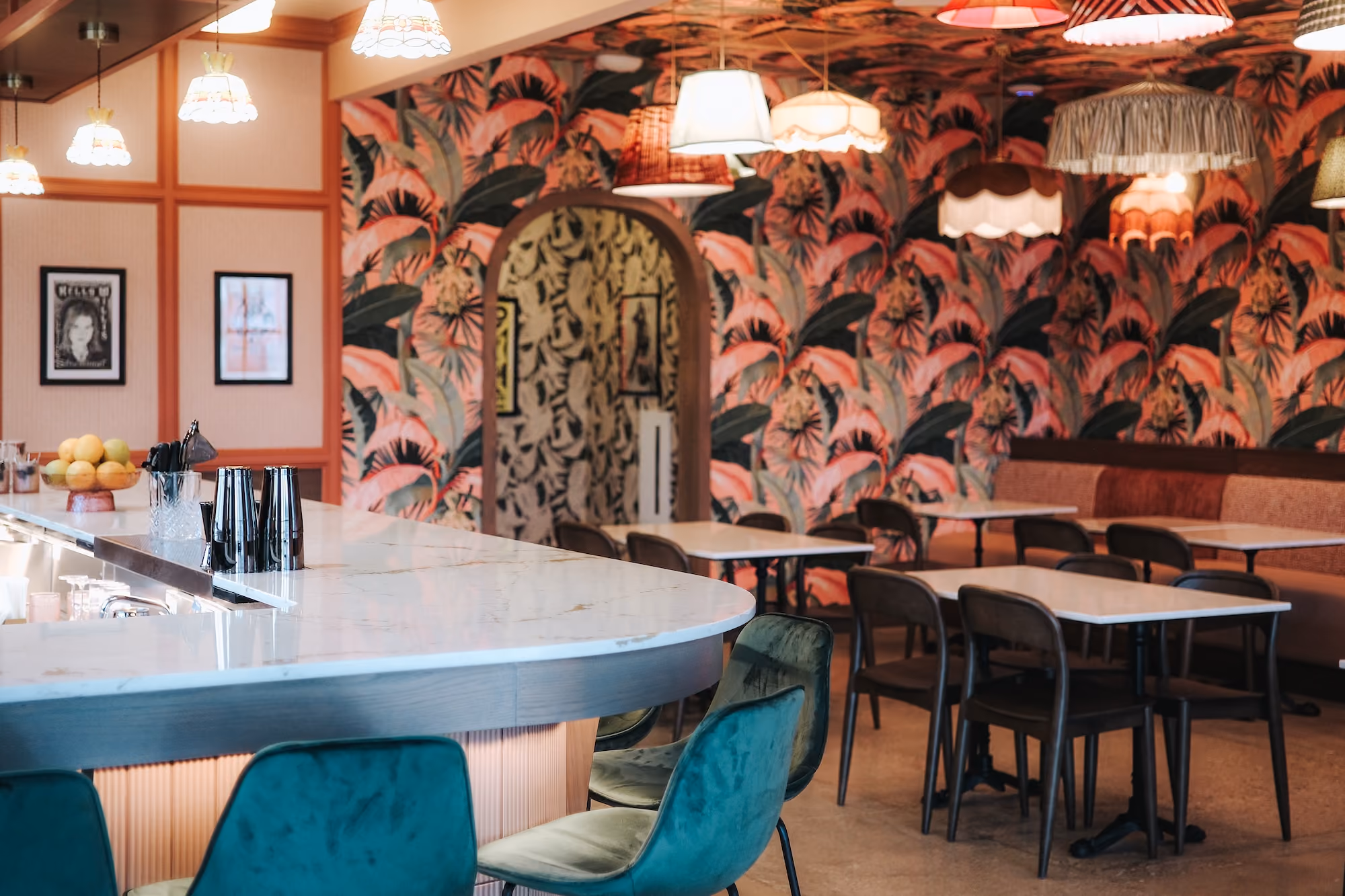 Private event room with palm-leaf wallpaper and a marble bar