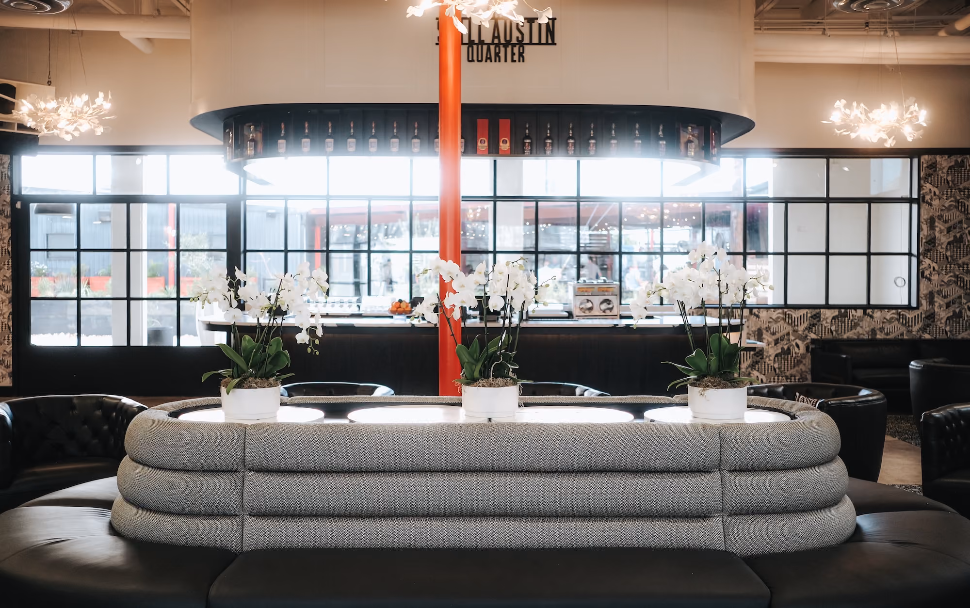 The Atrium bar with a curved banquette under a skylight