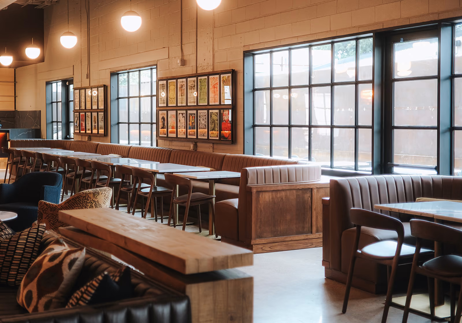 The Vinyl Lounge with leather booths, a long bar table and framed album art