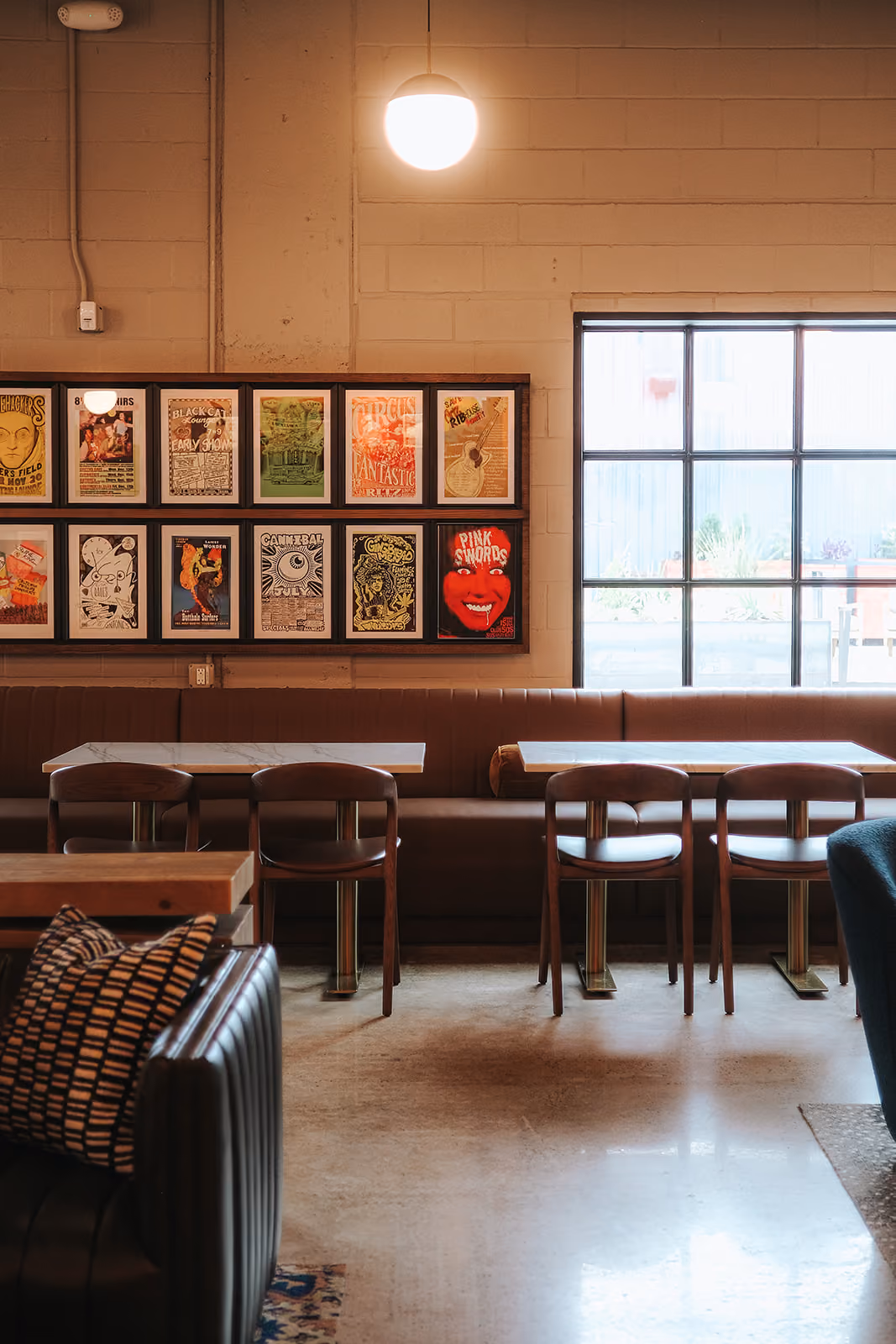 Window seating under framed music posters