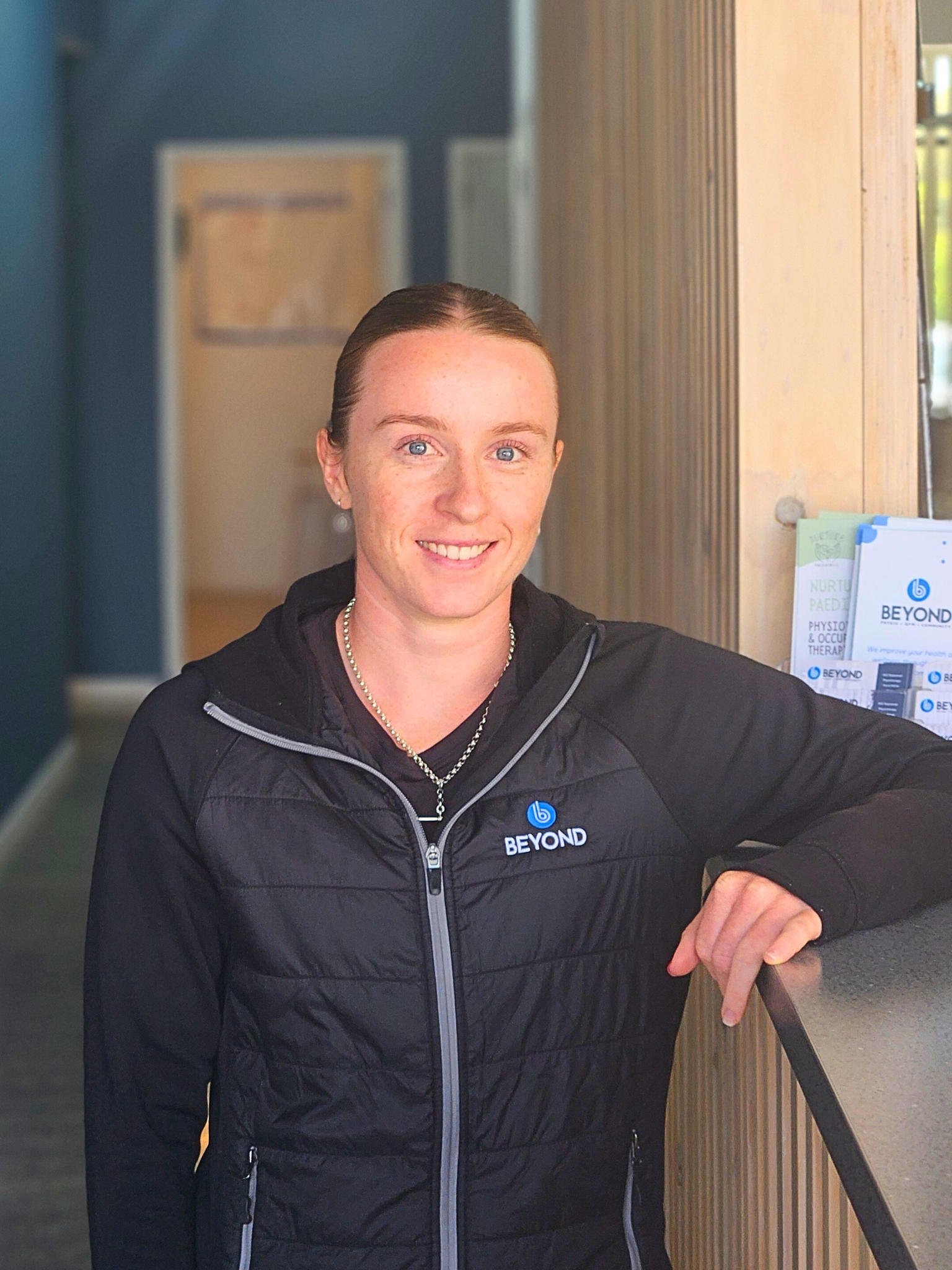 Brown haired physio smiling