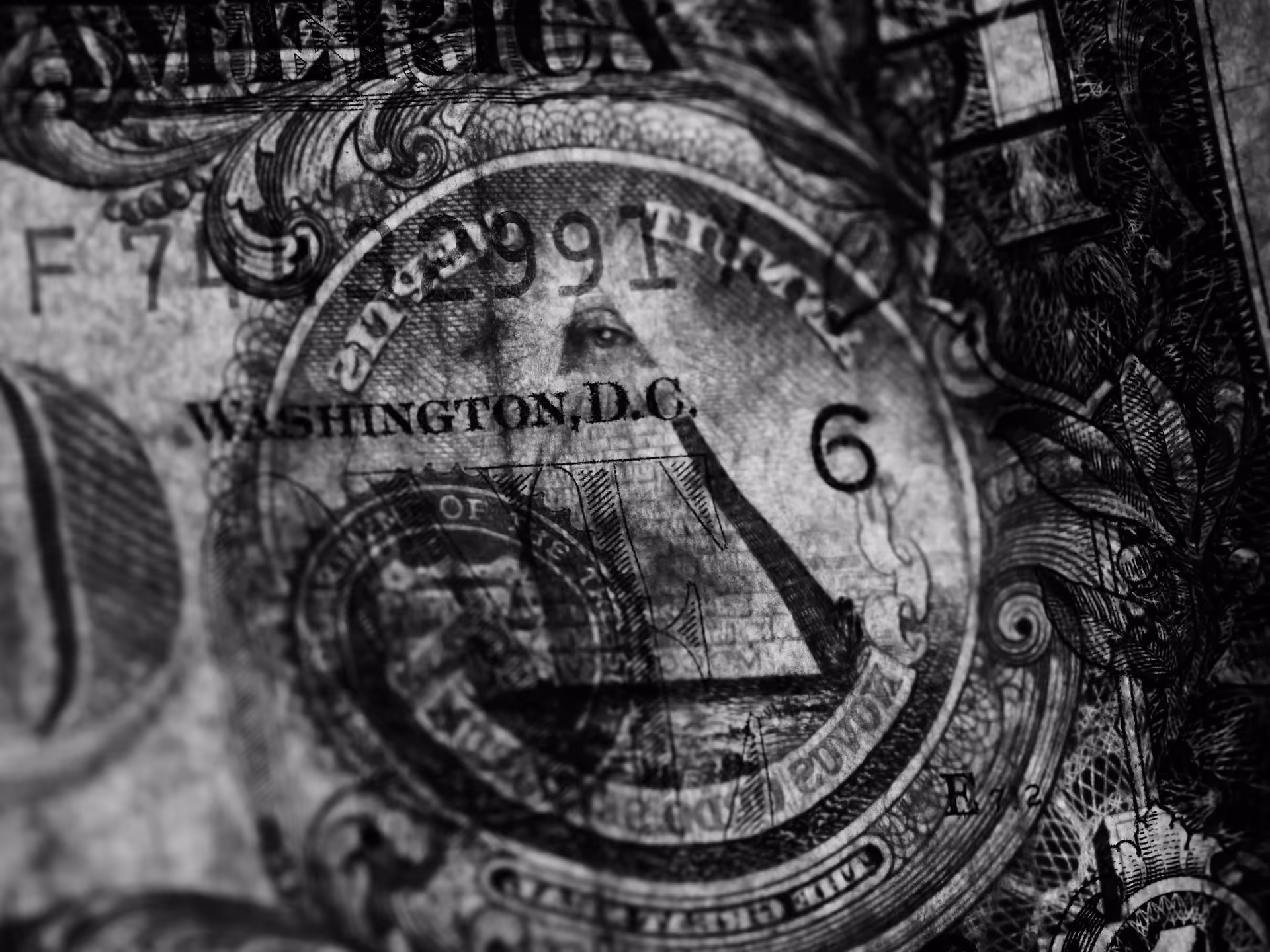 Smartphone showing stock market graph, US passport, cash bills, and credit cards on a wooden surface.